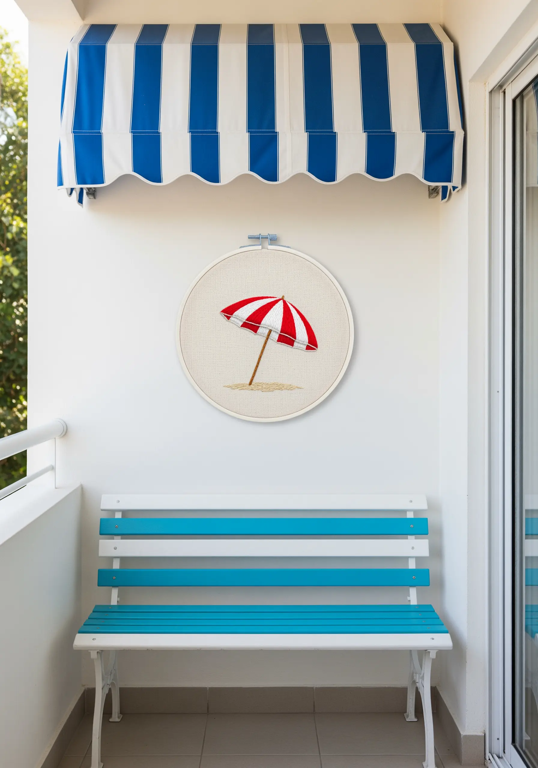 Embroidered red and white striped beach umbrella on a sandy shore.