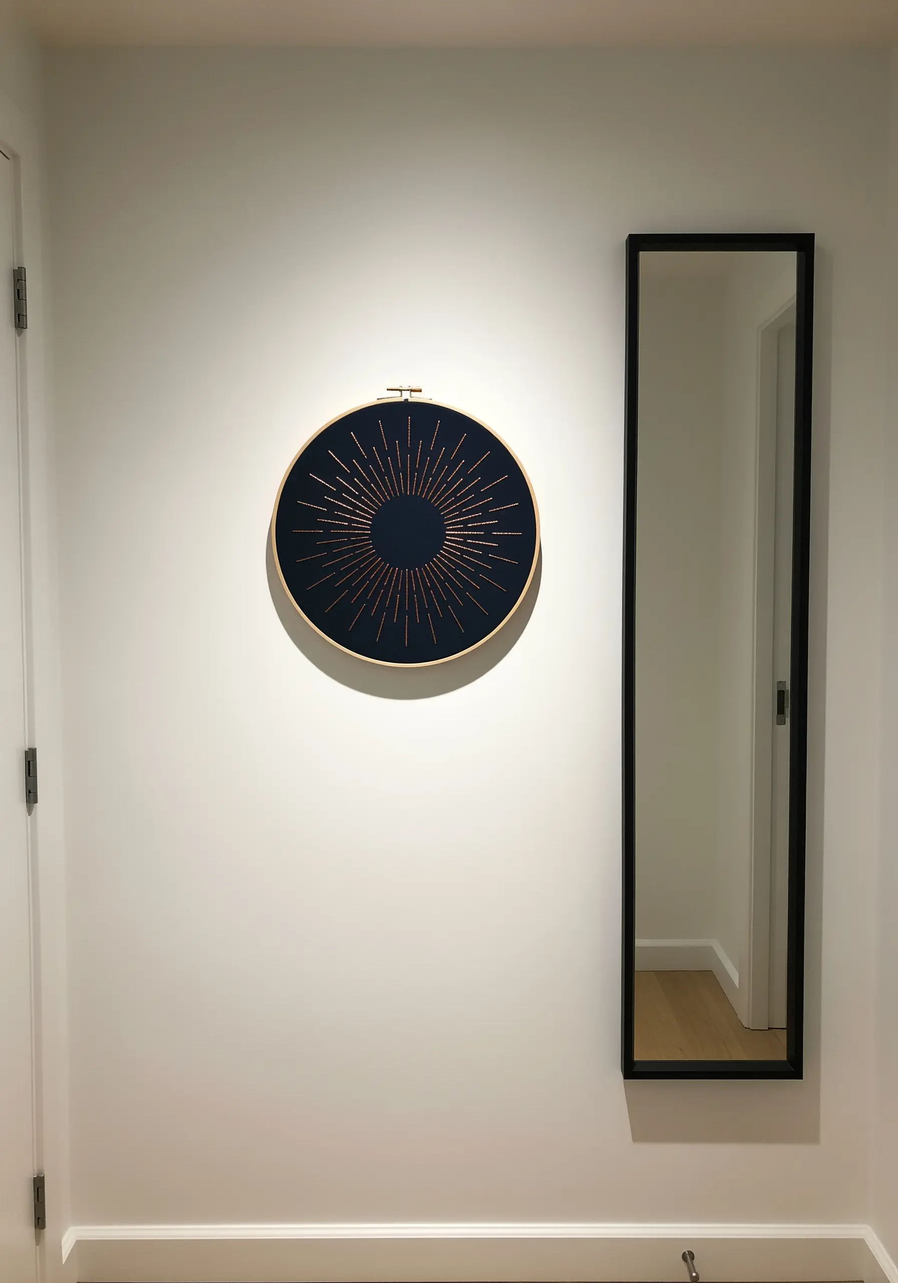 A sunburst or starburst pattern embroidered in copper metallic thread on dark navy fabric.