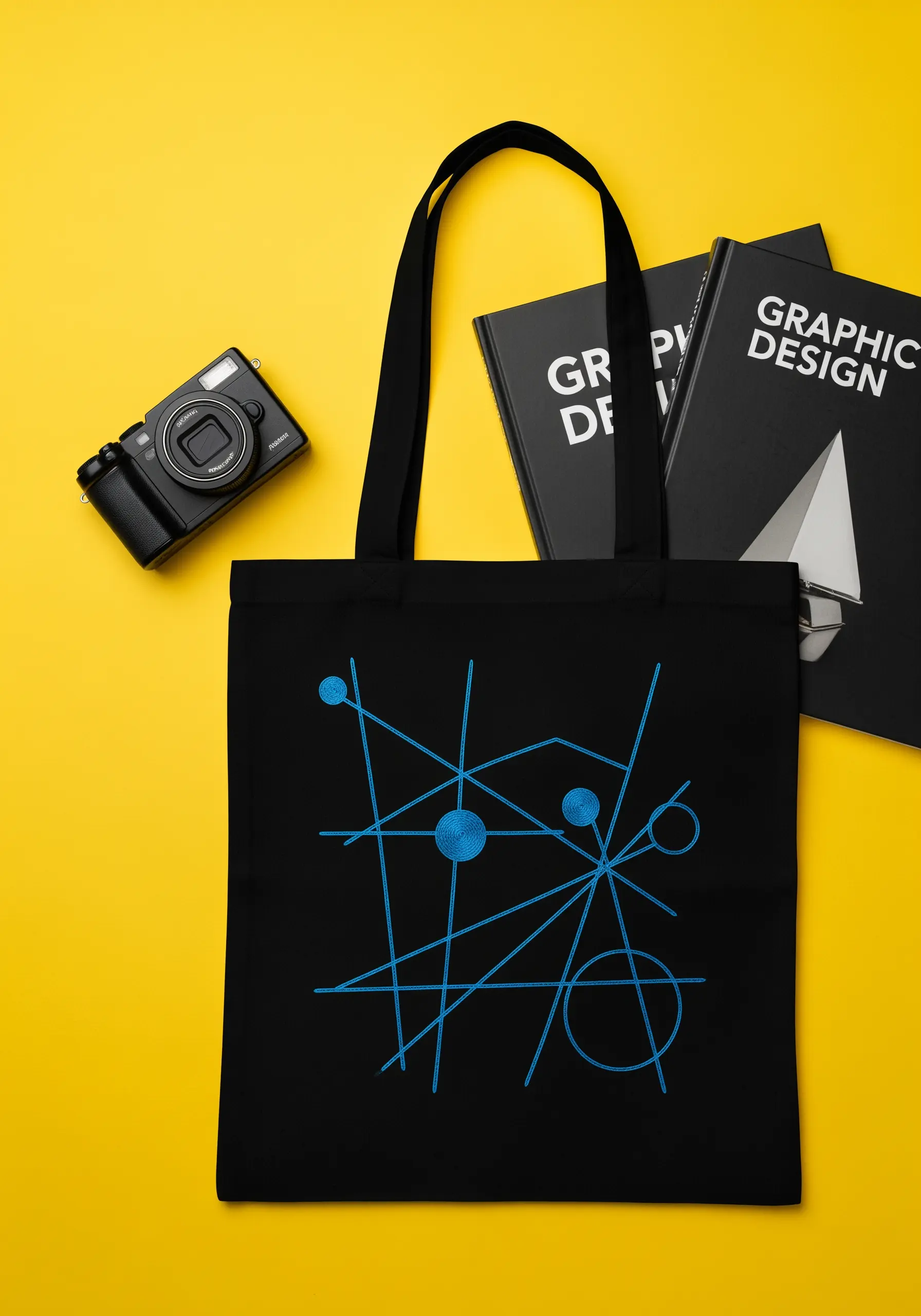 Abstract geometric design with blue lines and filled circles on a black tote.