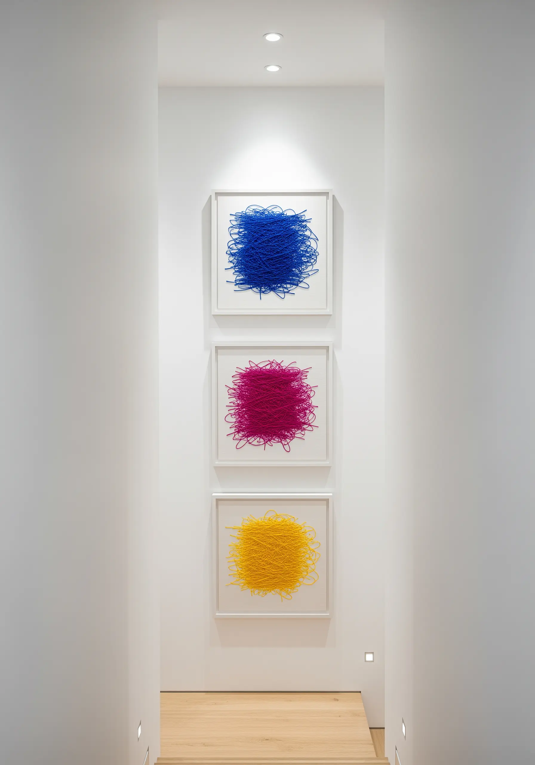 Three framed pieces of abstract fiber art, each a dense tangle of a single bold color.