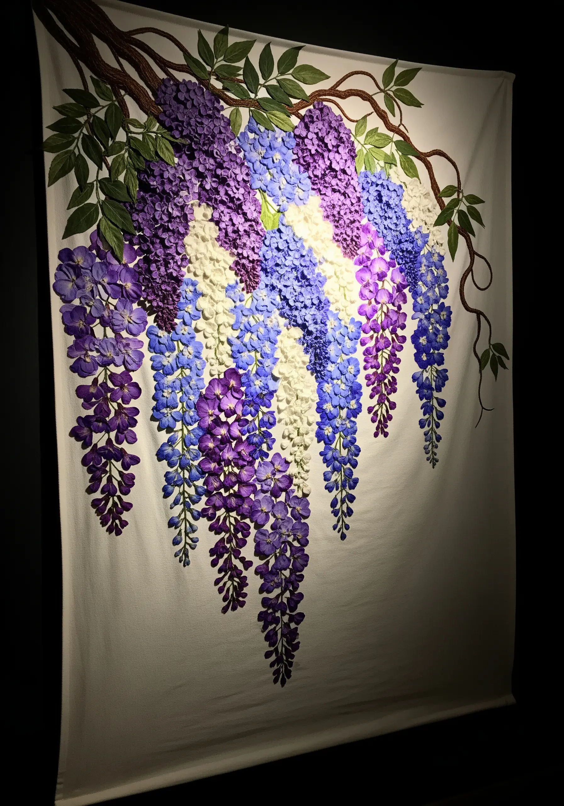 A large wall tapestry with three-dimensional, cascading wisteria flowers in shades of purple and white.
