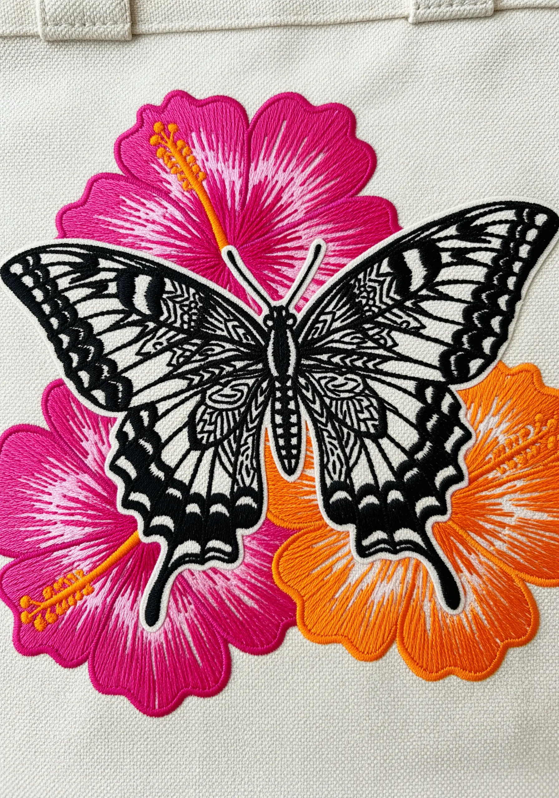 A graphic black-and-white butterfly with sharp edges over vibrant pink and orange flowers.