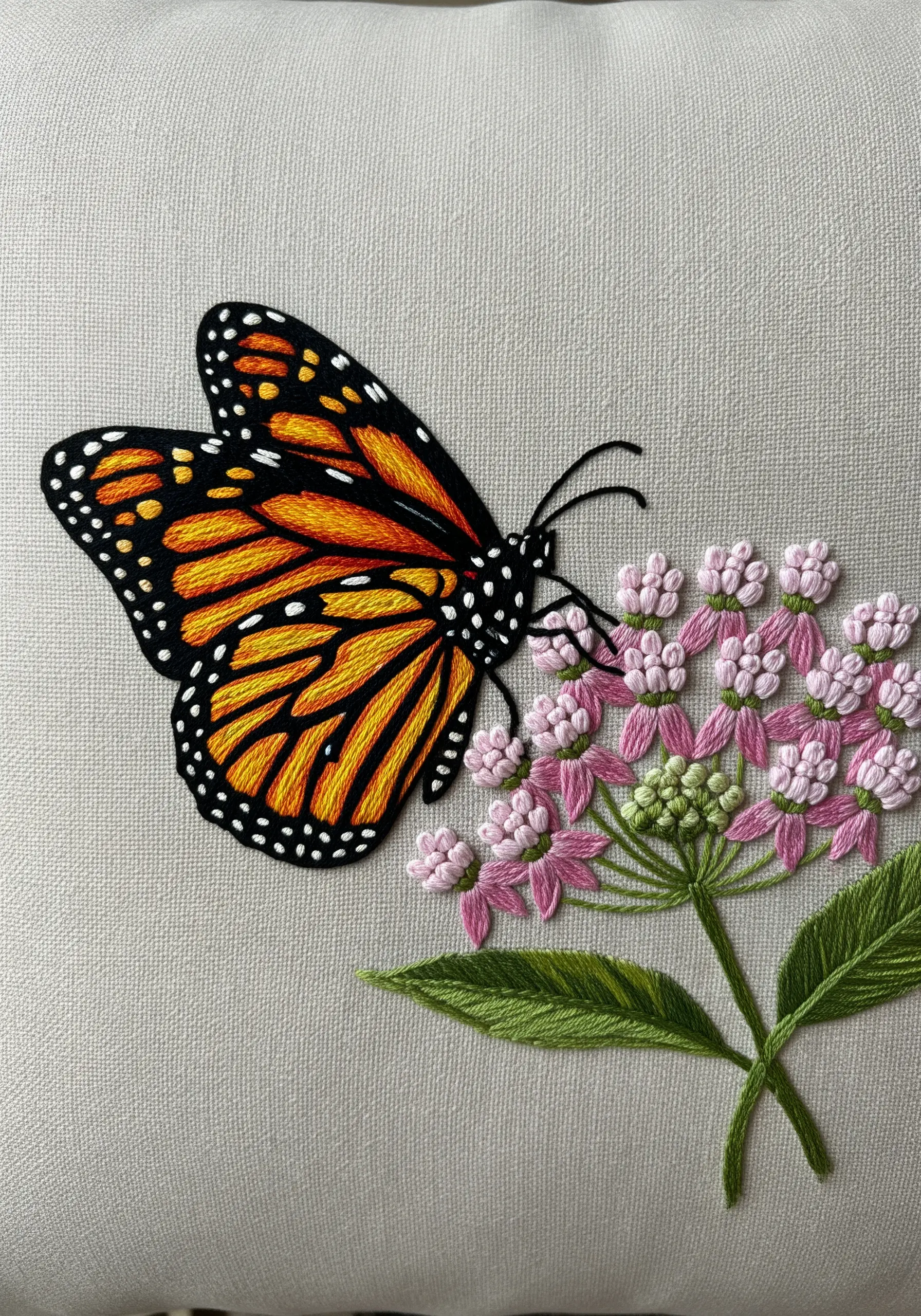 A detailed monarch butterfly with sharp outlines on a cluster of pink flowers.