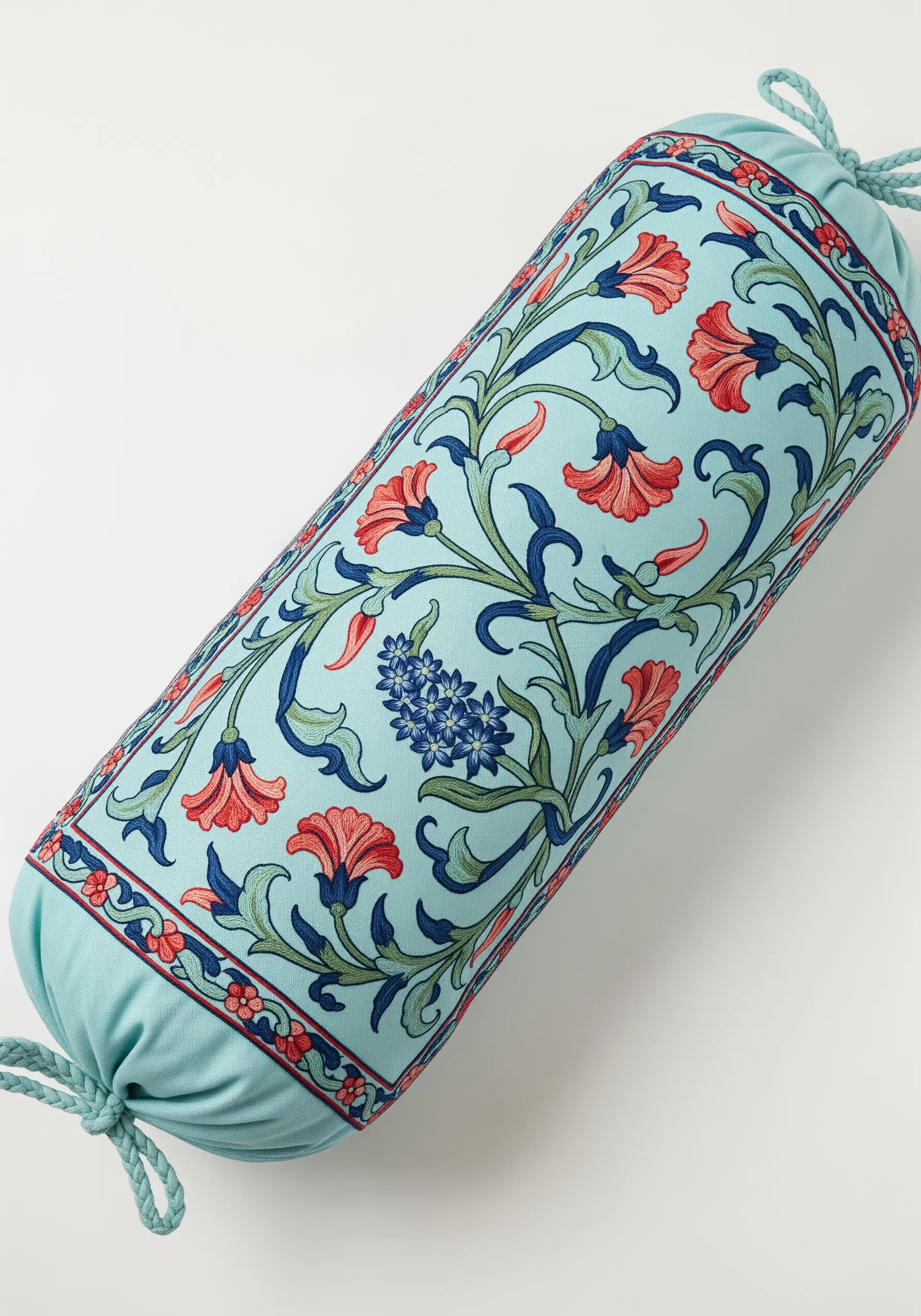 A floral vine pattern embroidered around a light blue bolster cushion