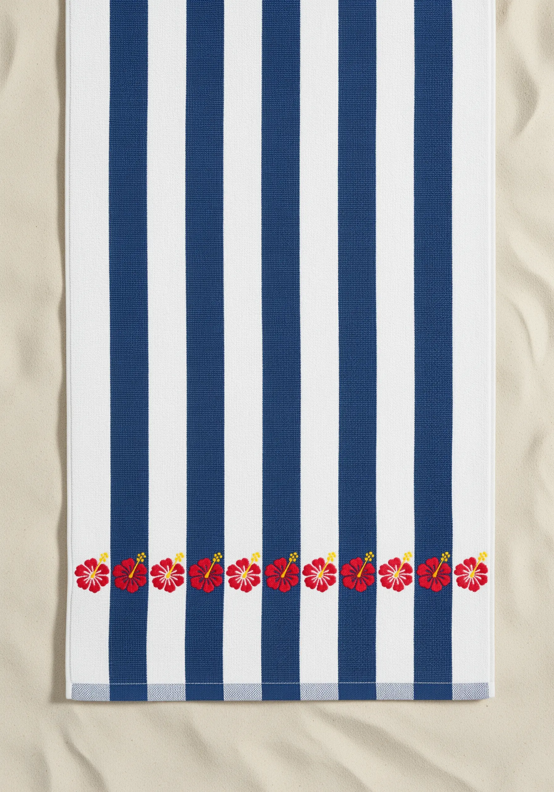 A border of small red hibiscus flowers embroidered along the bottom of a blue and white striped towel.