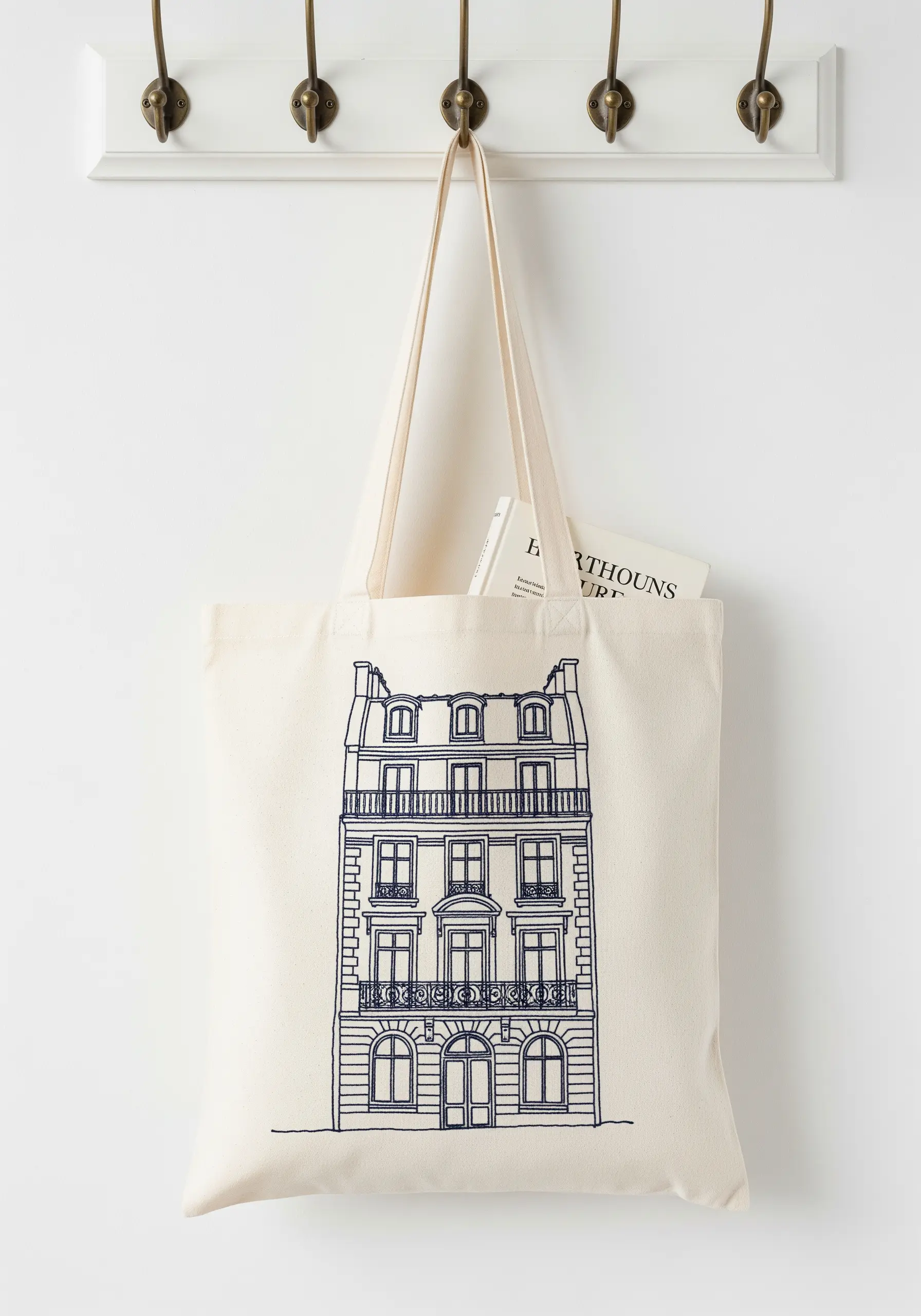 Detailed Parisian building embroidered in navy thread on a cream tote bag.
