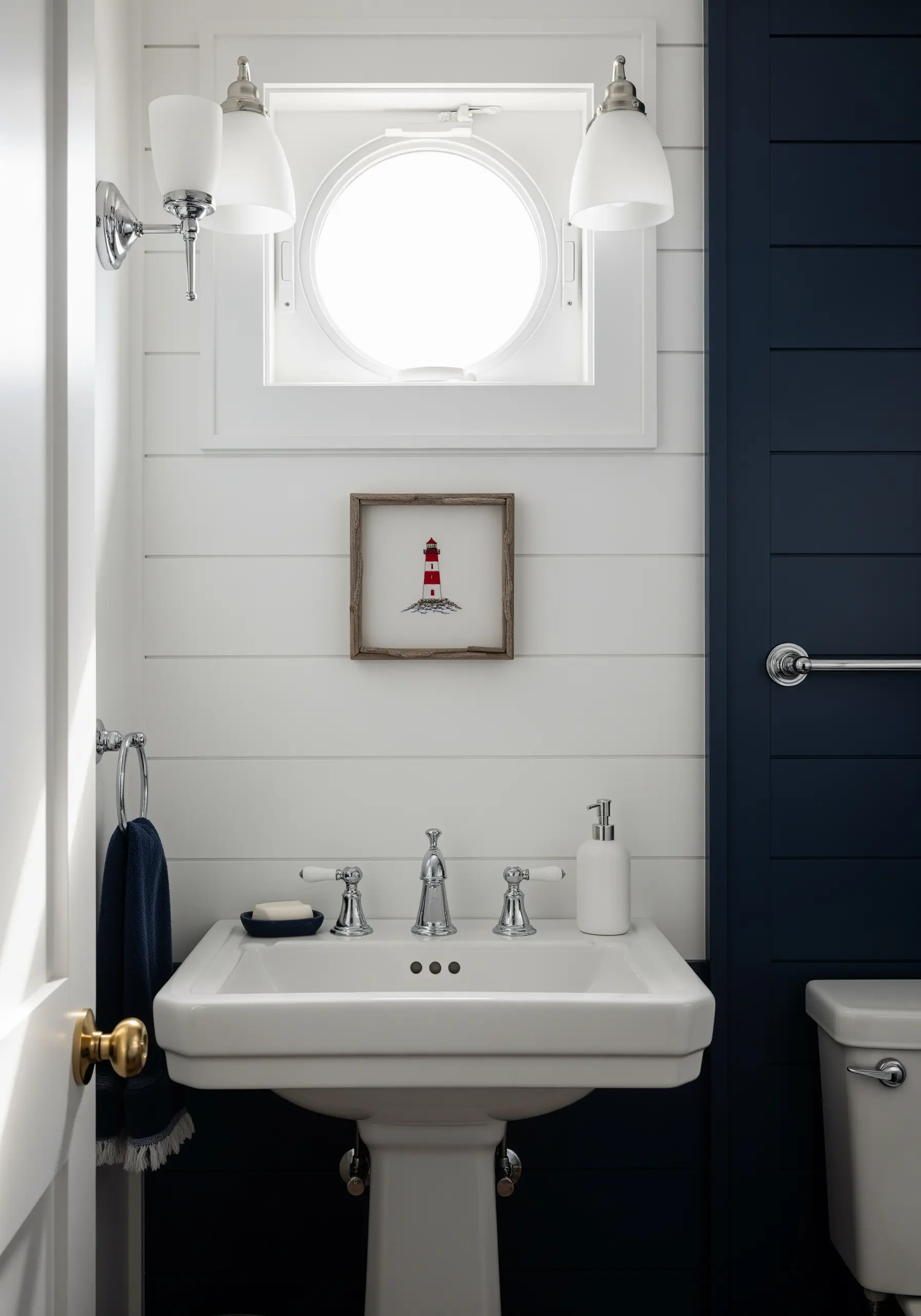 Framed lighthouse embroidery with clean satin stitch and French knot details.