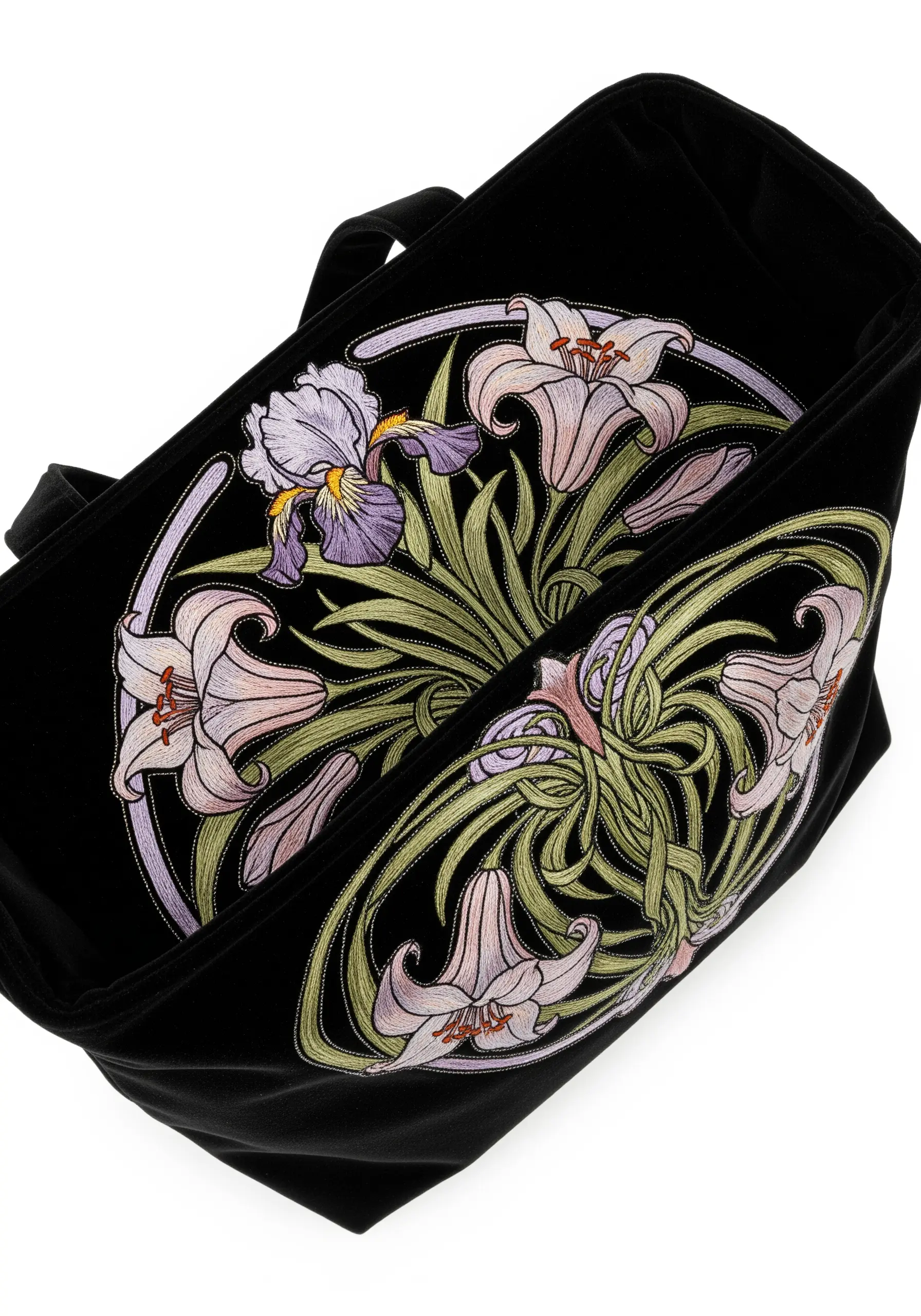 An Art Nouveau-style design of lilies and irises embroidered inside a black velvet tote bag.