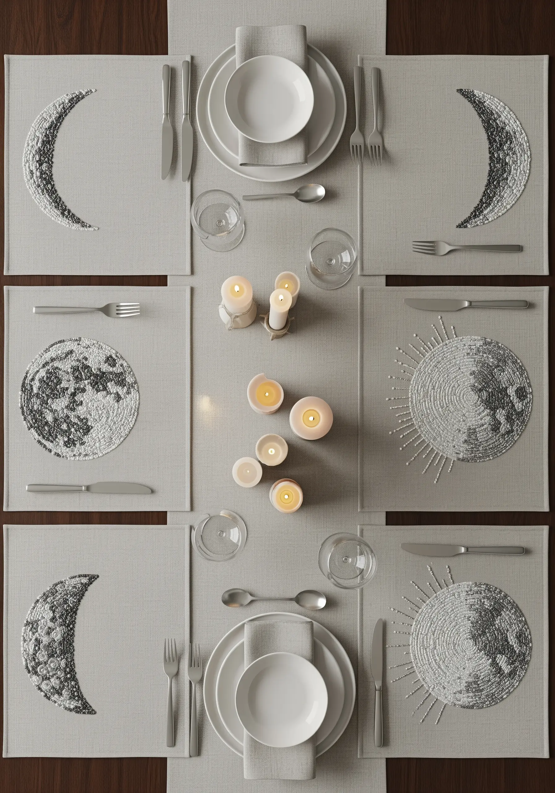 A table setting with linen placemats embroidered with beaded moon phases in silver and gray.