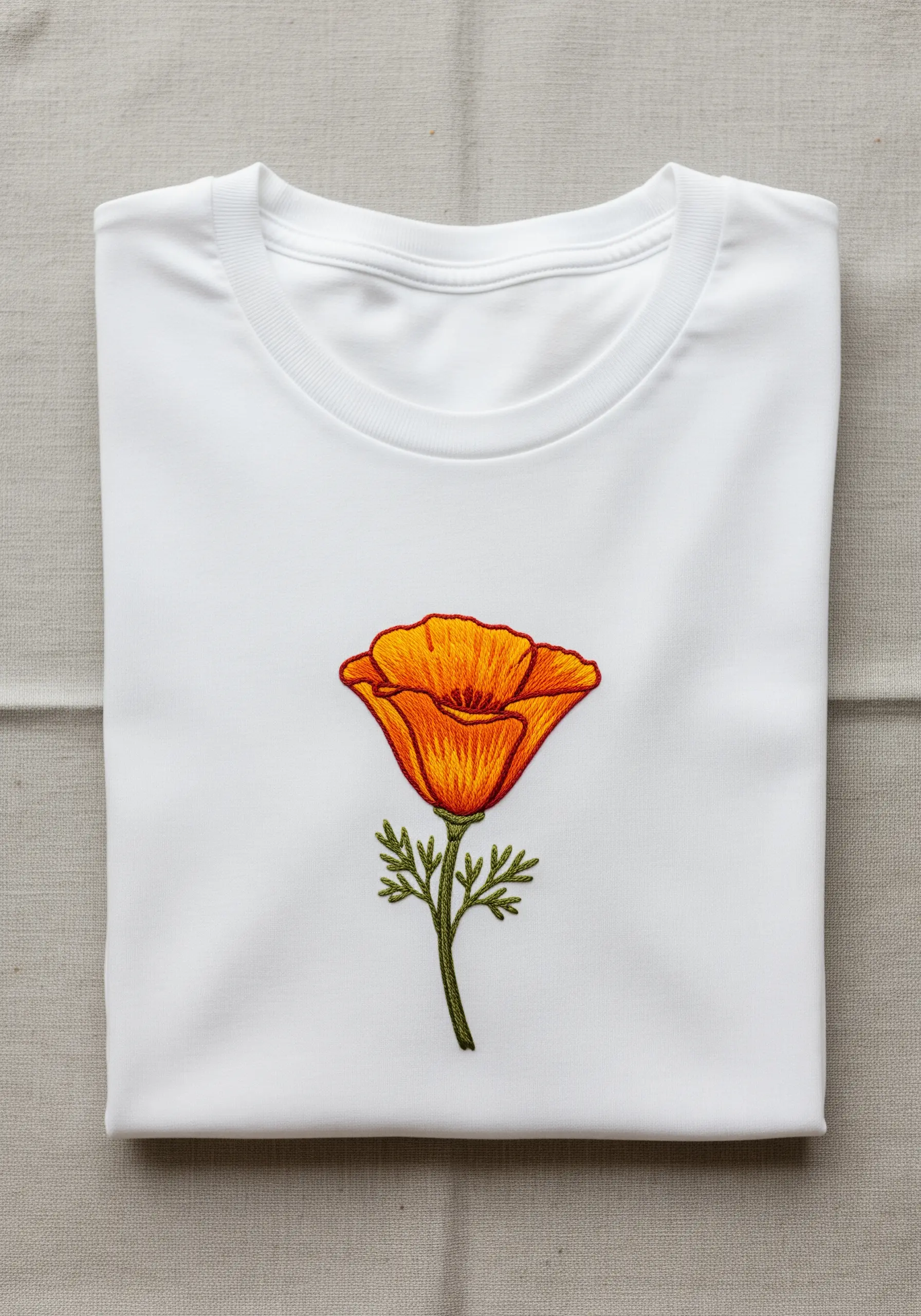 Realistic California poppy with orange gradient petals embroidered on a t-shirt.