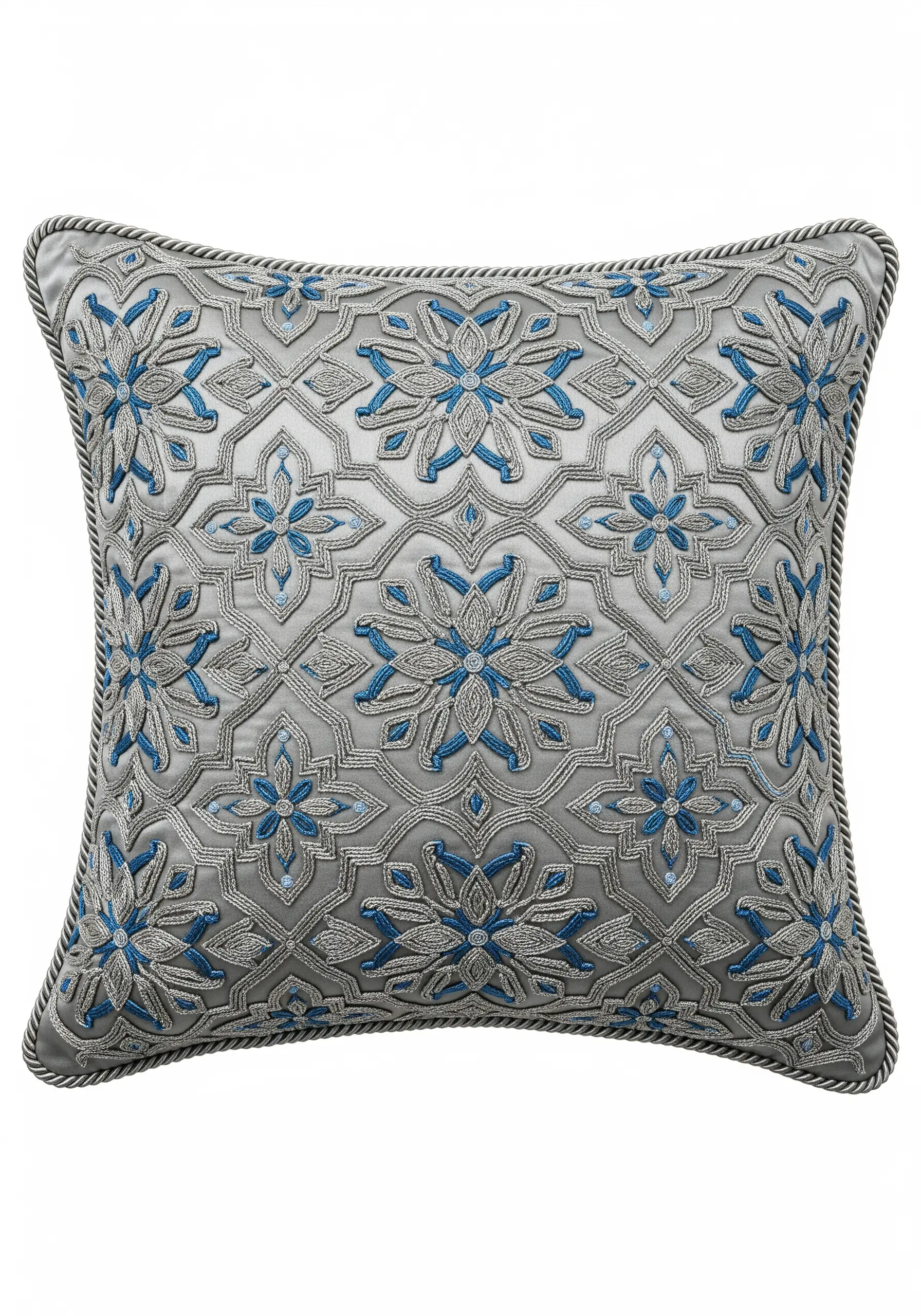 Geometric floral pattern in silver metallic and blue matte threads on a grey cushion