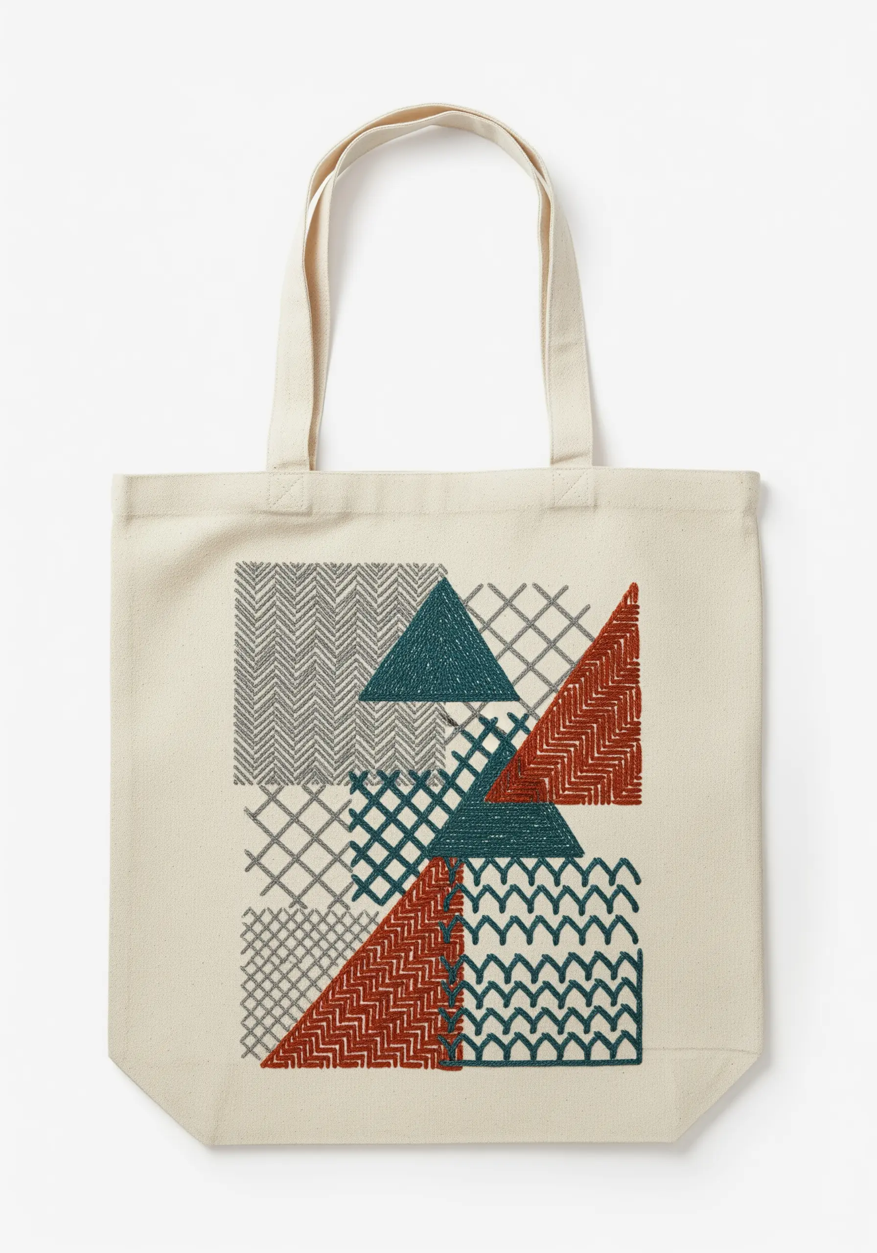 Geometric block pattern on a tote bag filled with various textured stitches.