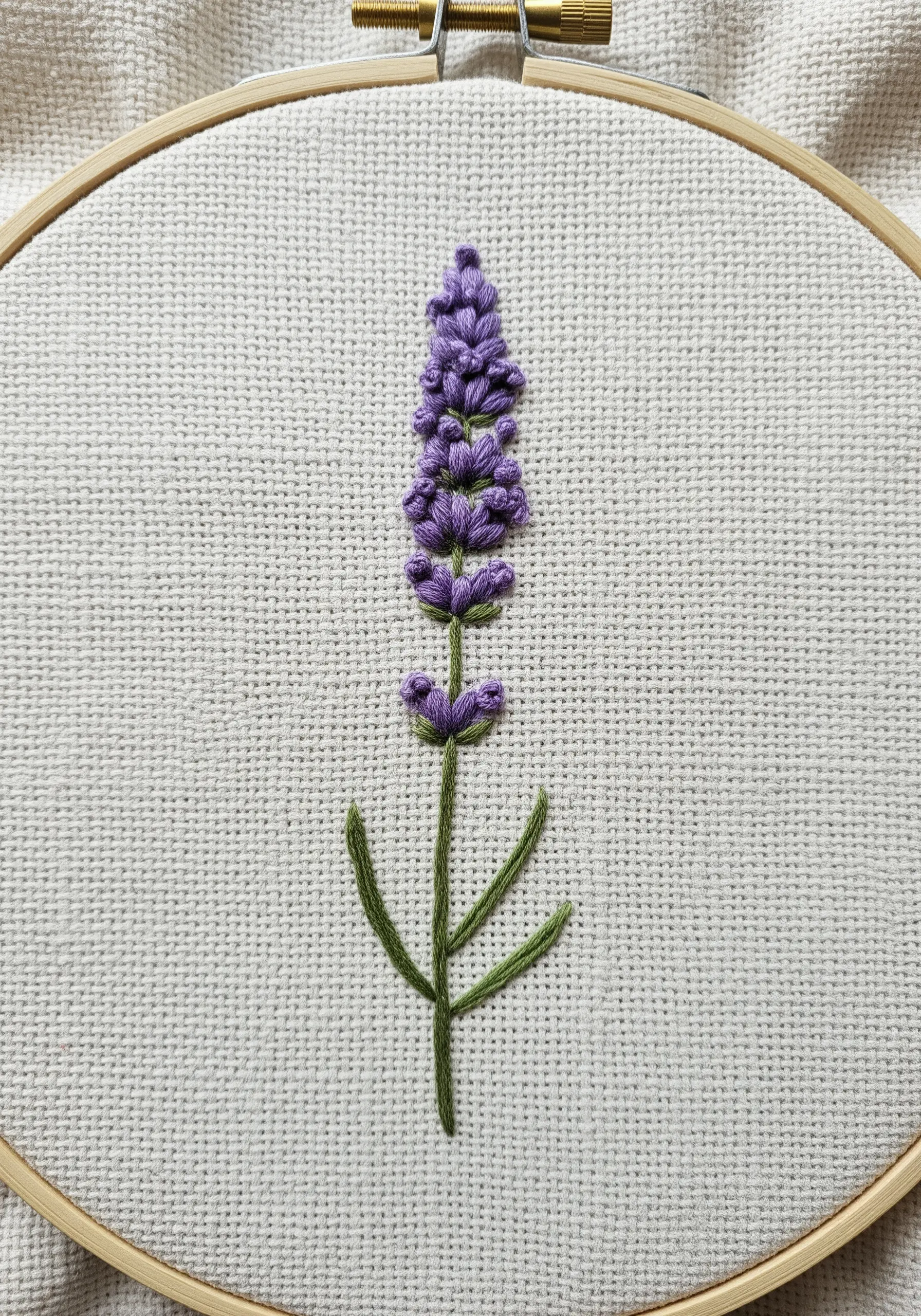 A single stalk of lavender embroidered with dimensional purple knots and a green stem.