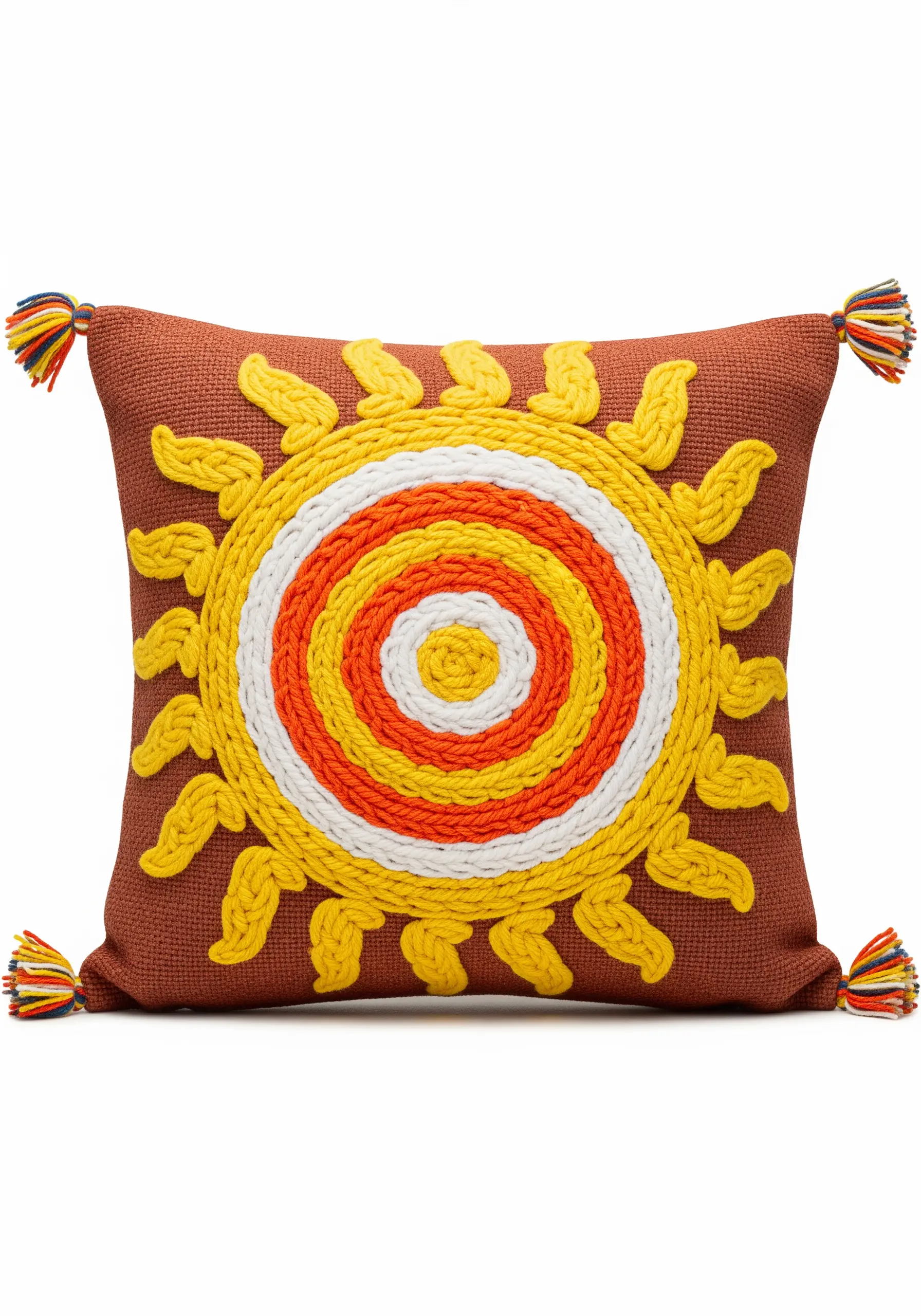 A sun motif created with chunky couched yarn on a terracotta-colored cushion