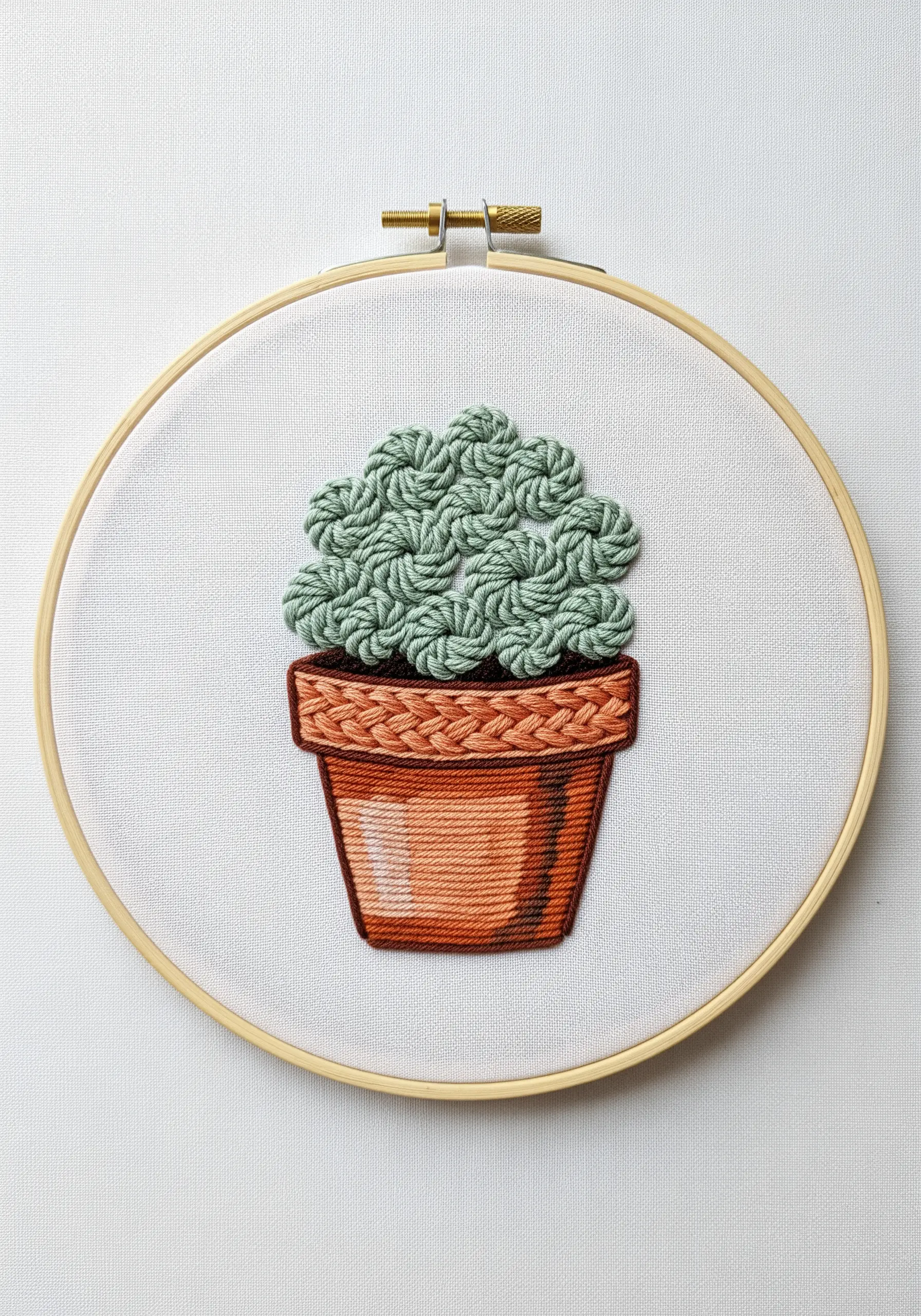 A potted succulent embroidered with 3D woven picot stitches for the leaves.