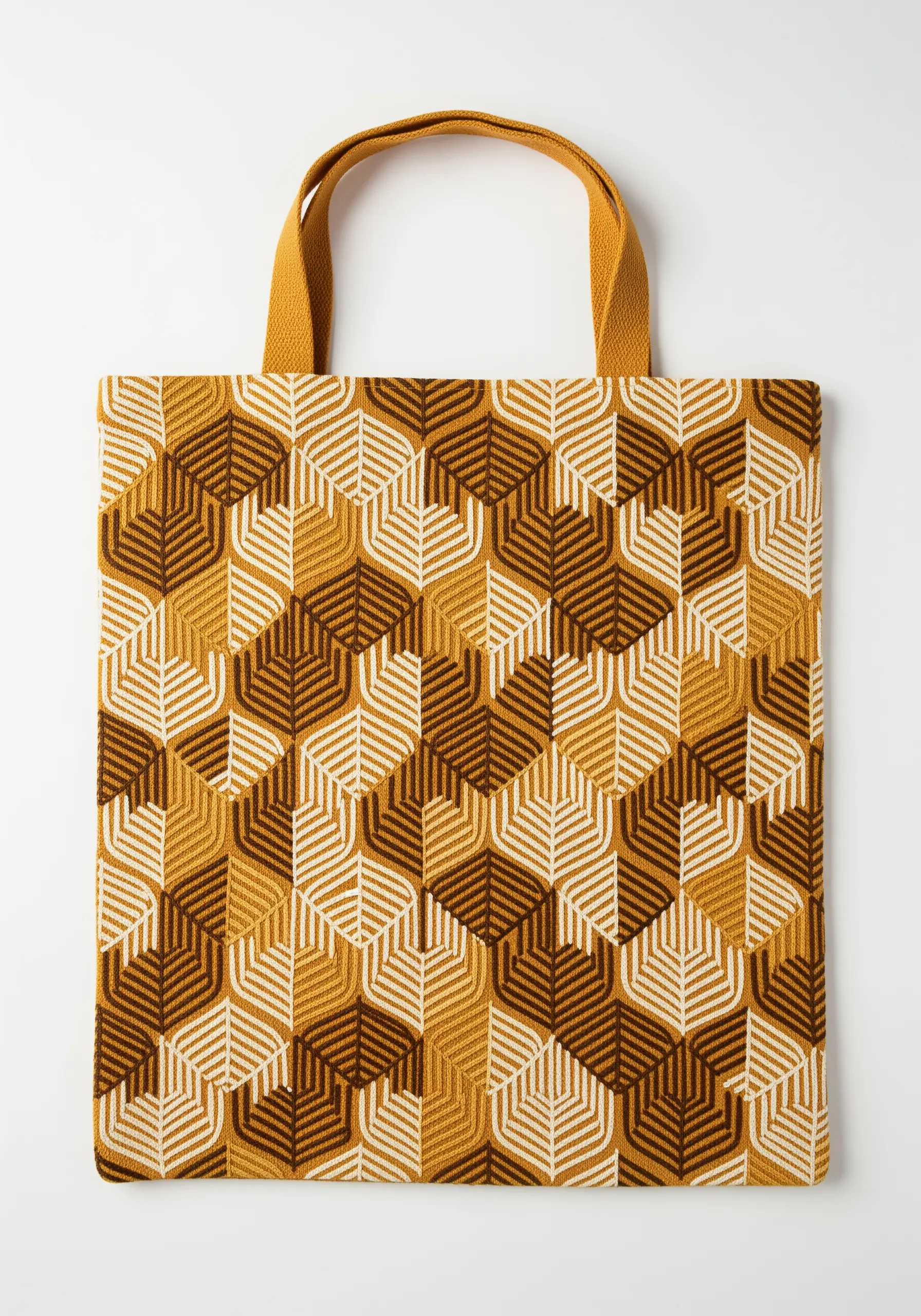 A geometric tote bag pattern made of stylized leaves in ochre, brown, and white.