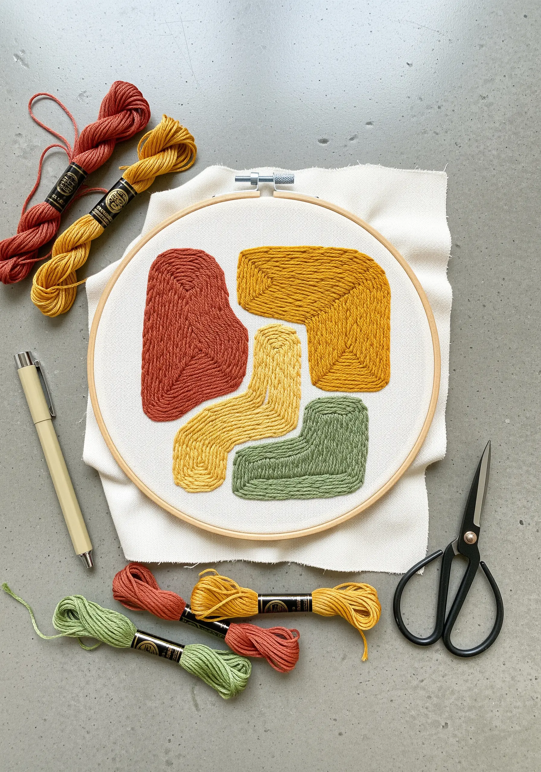 Abstract color block embroidery in rust, gold, and green with directional satin stitches.