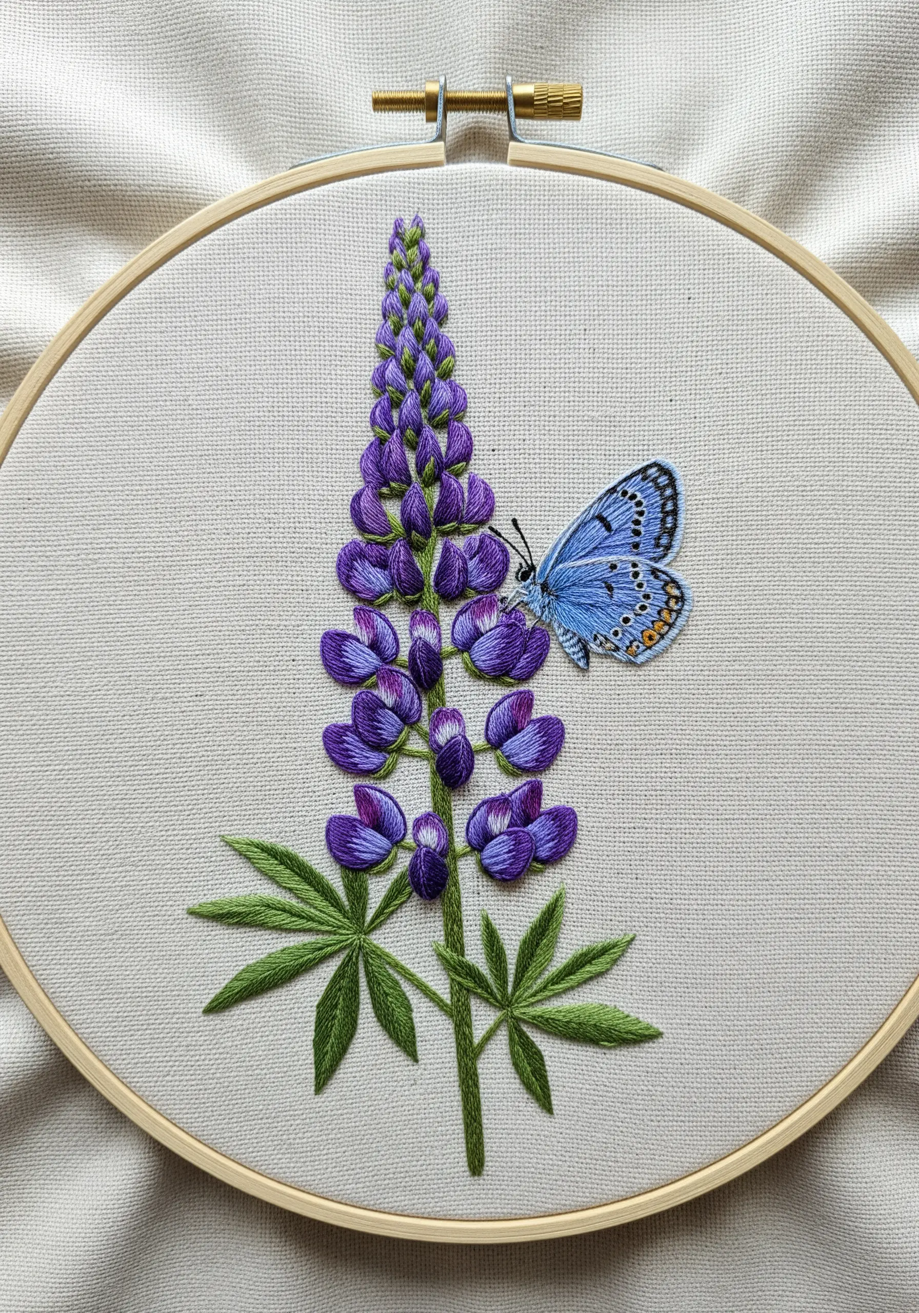 A small blue butterfly on a tall purple lupine flower with individually stitched petals.