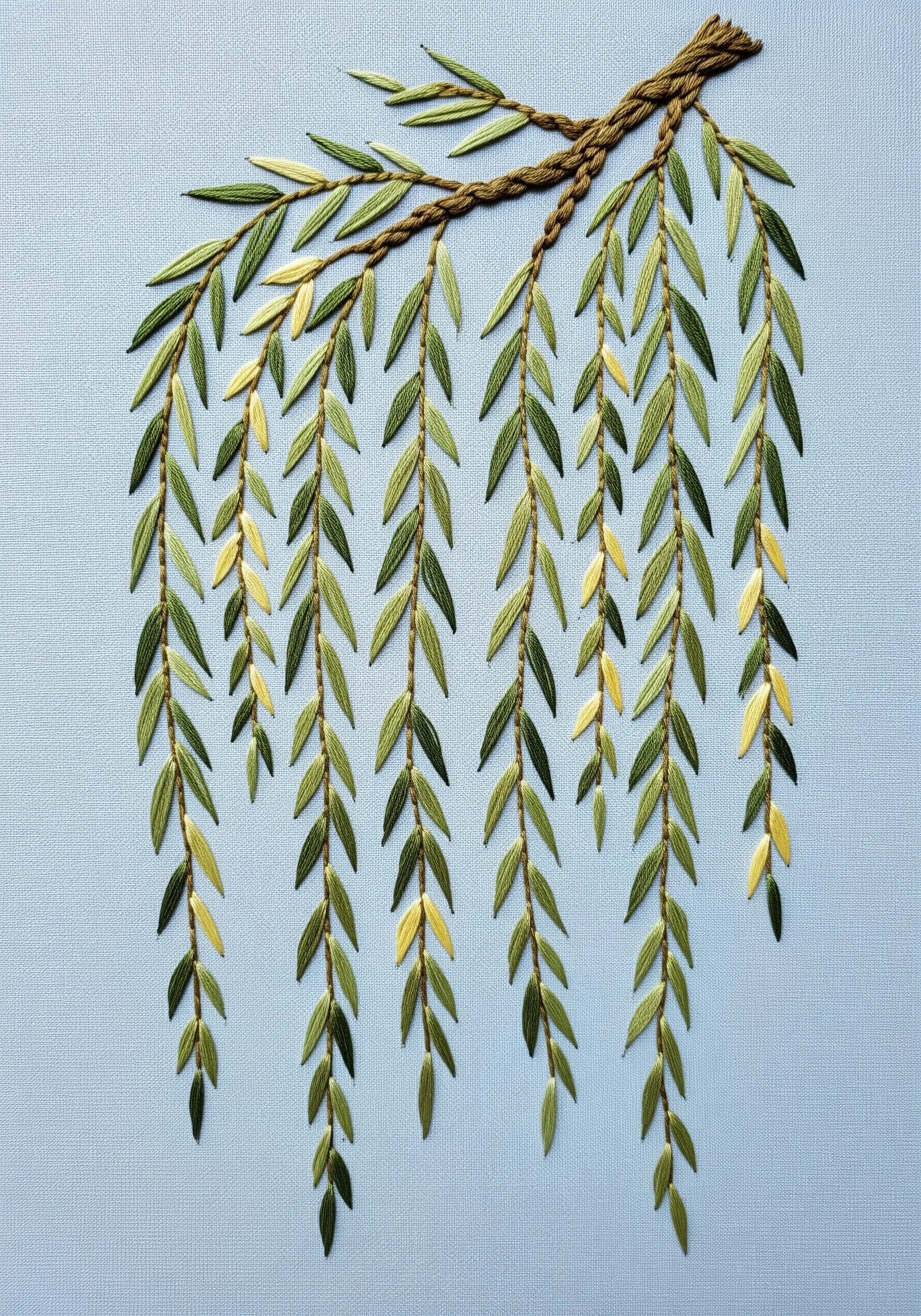 Embroidery of a weeping willow branch with long, hanging leaves in shades of green and yellow.