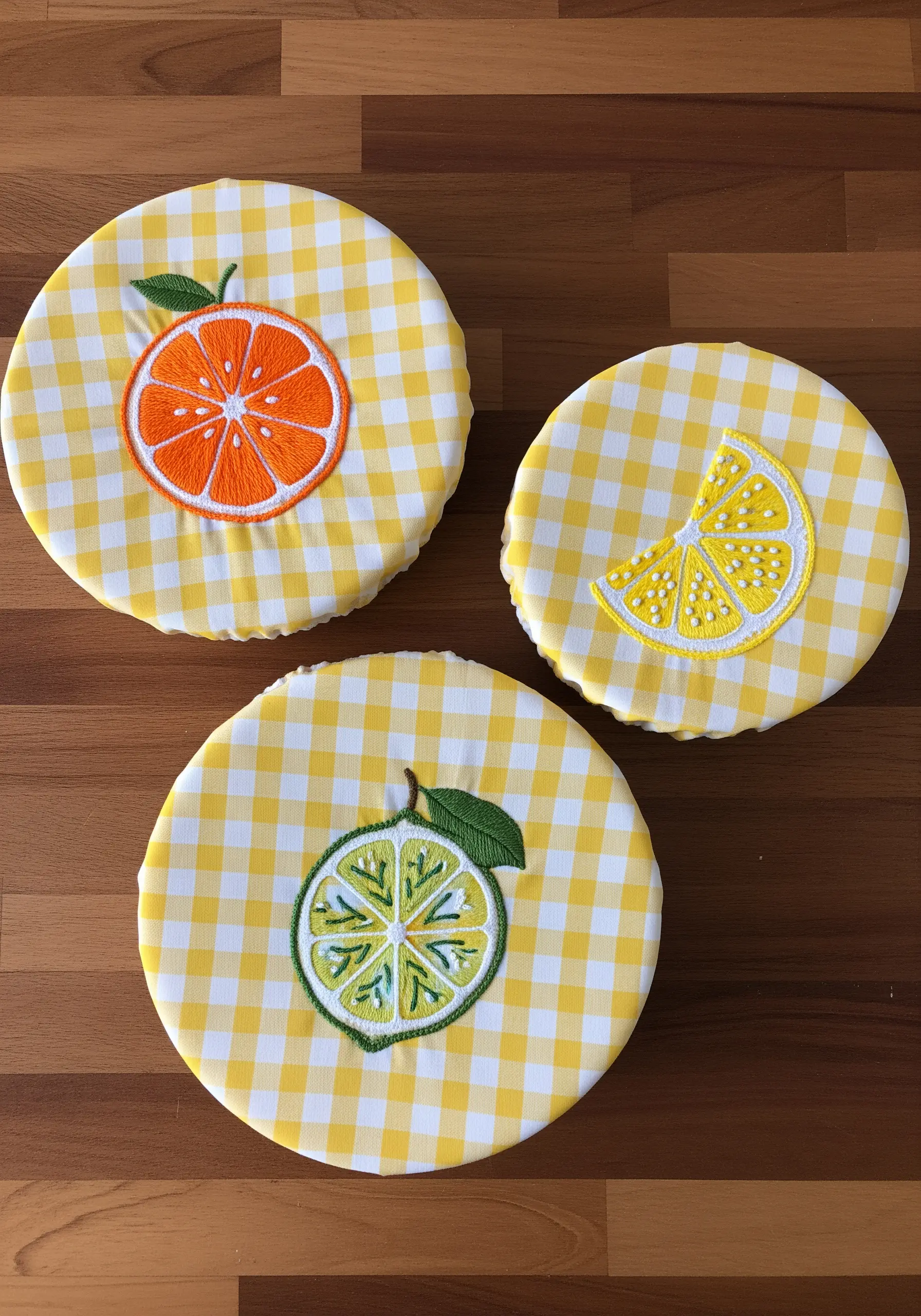 Yellow gingham bowl covers with embroidered orange, lemon, and lime slices.