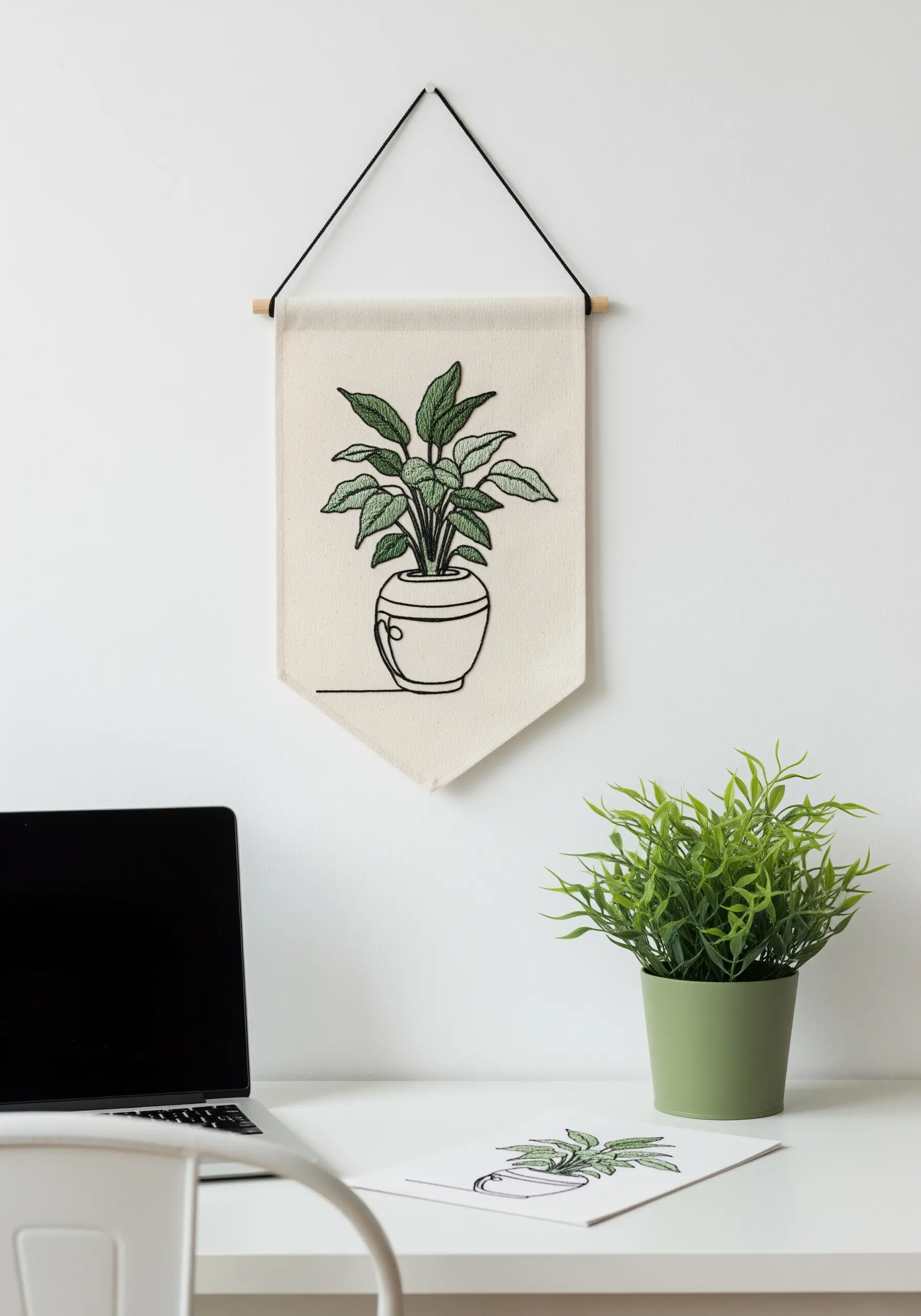 A potted plant embroidered in a continuous line style with filled-in leaves on a wall banner