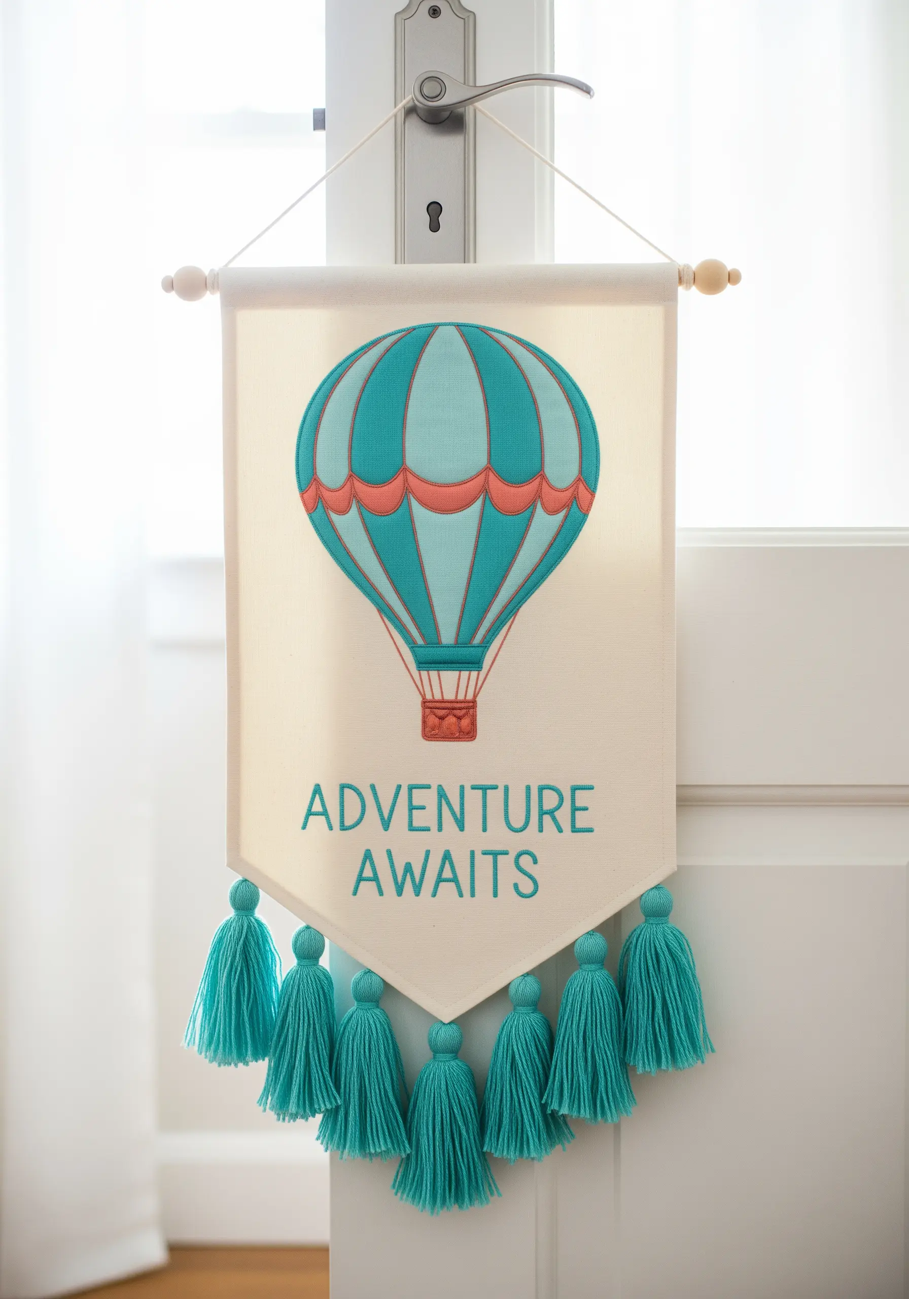 A fabric banner with a large appliqué hot air balloon and the words 'Adventure Awaits'.