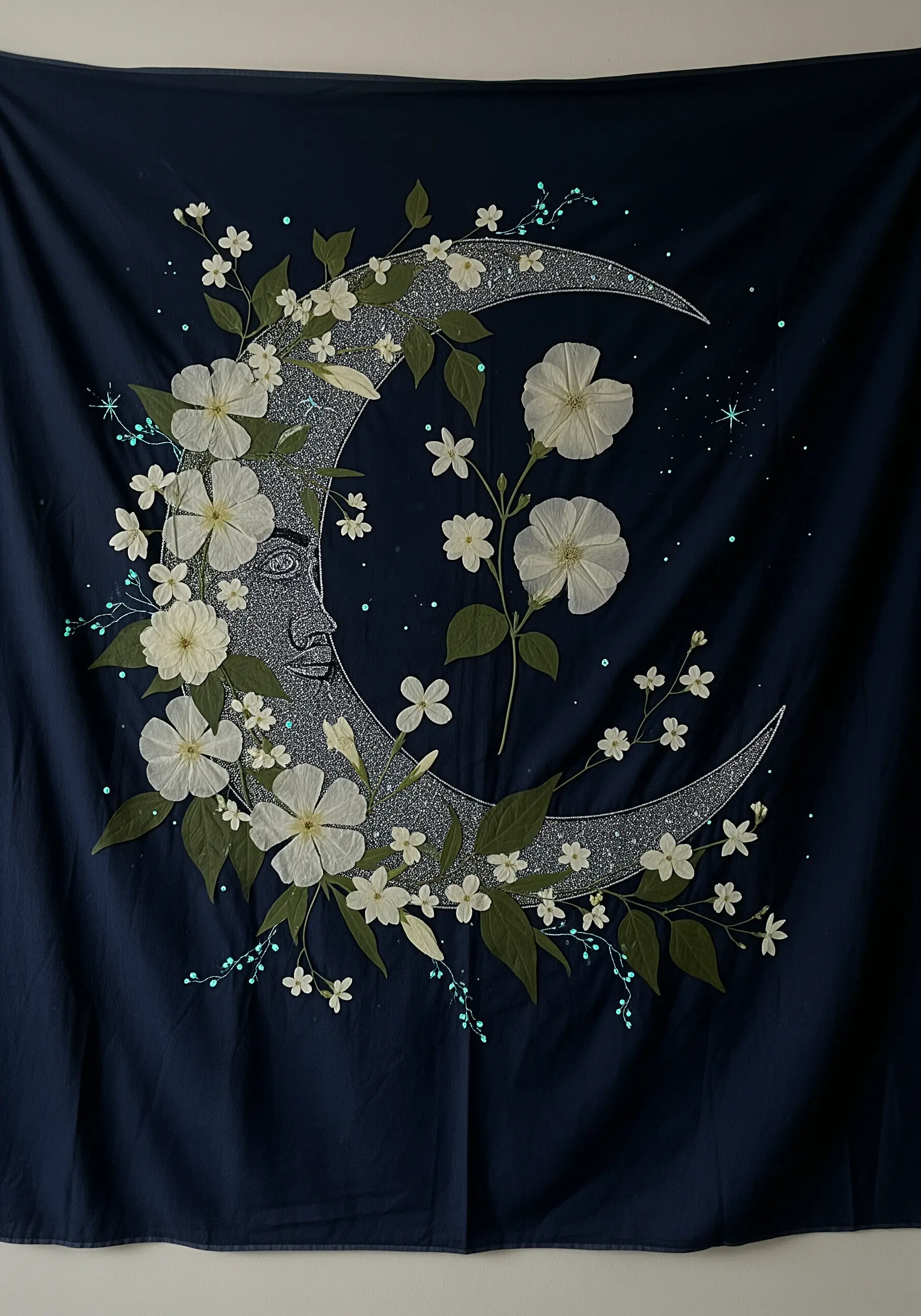 A celestial tapestry on navy fabric, featuring a silver crescent moon adorned with white flowers.