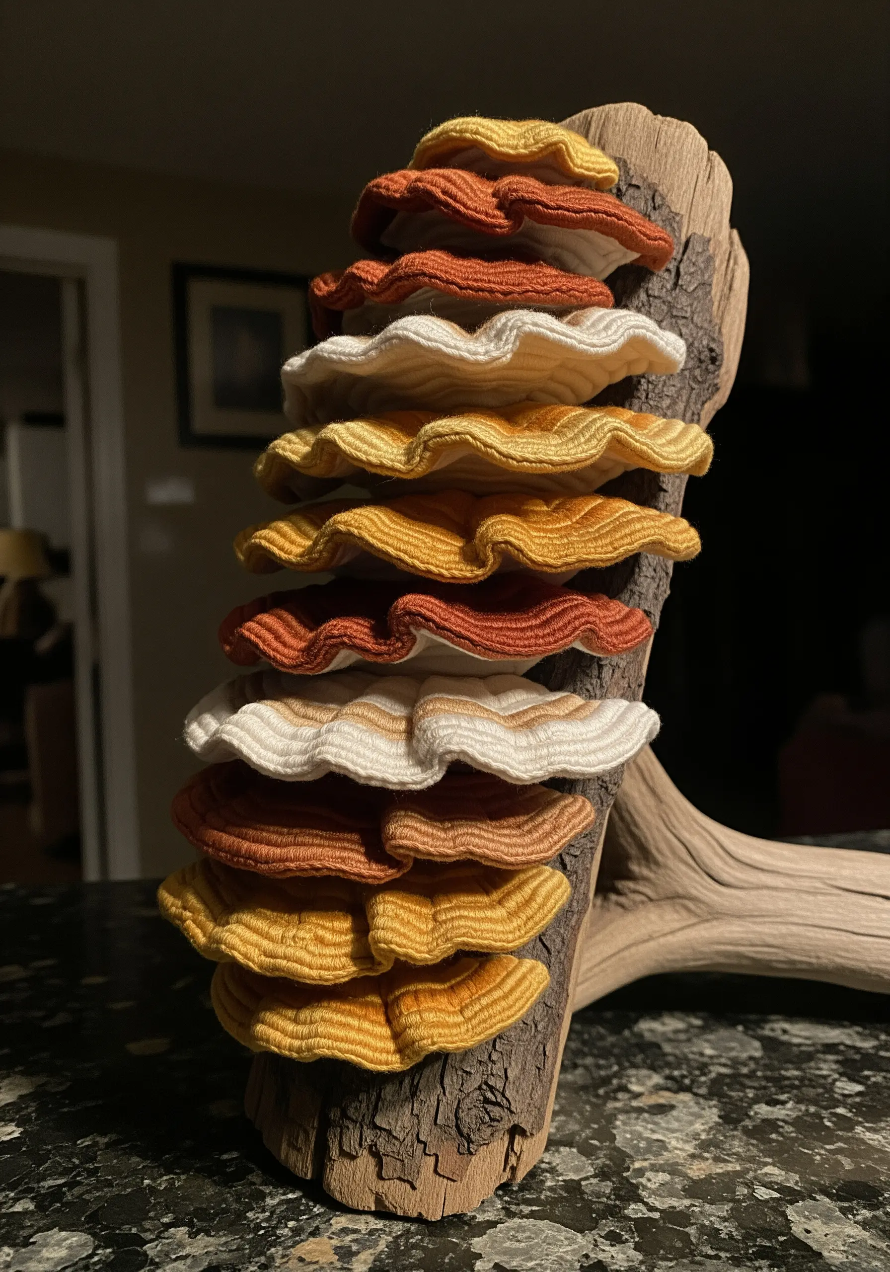 3D stumpwork embroidery of shelf fungi attached to a piece of real wood.