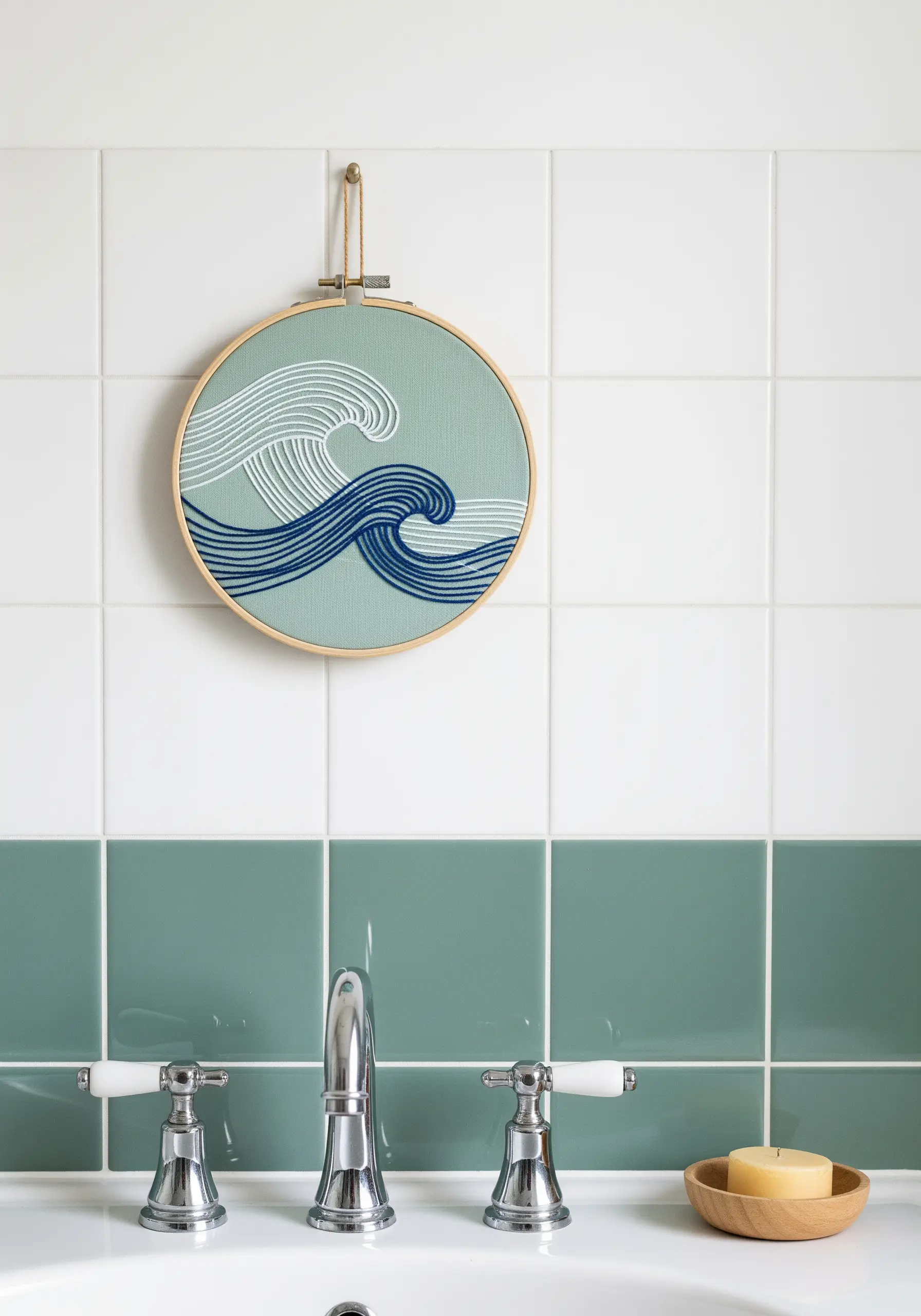 Embroidery hoop with stylized waves in shades of blue and white.