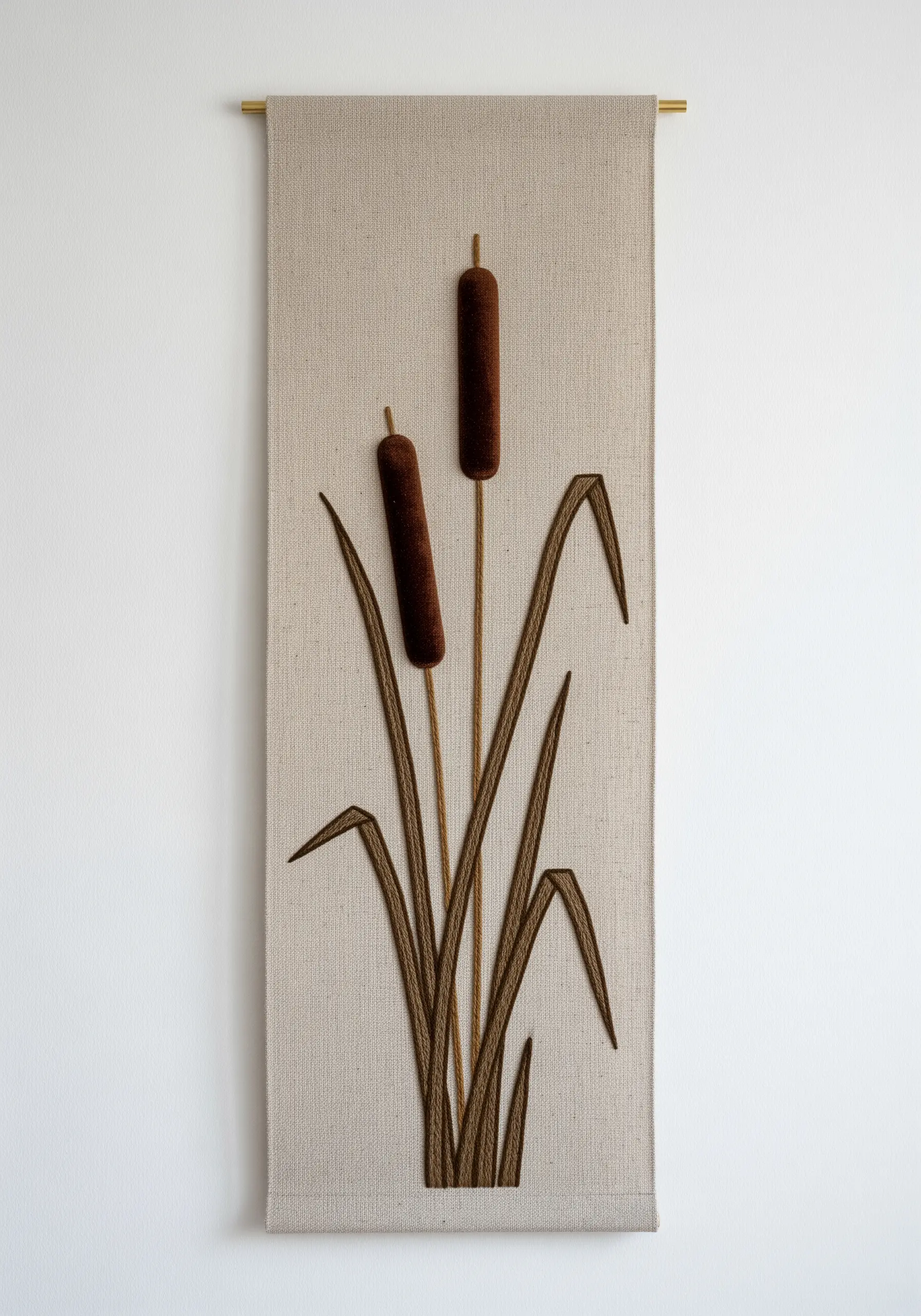 A minimalist wall hanging of cattails with plush, 3D embroidered heads.