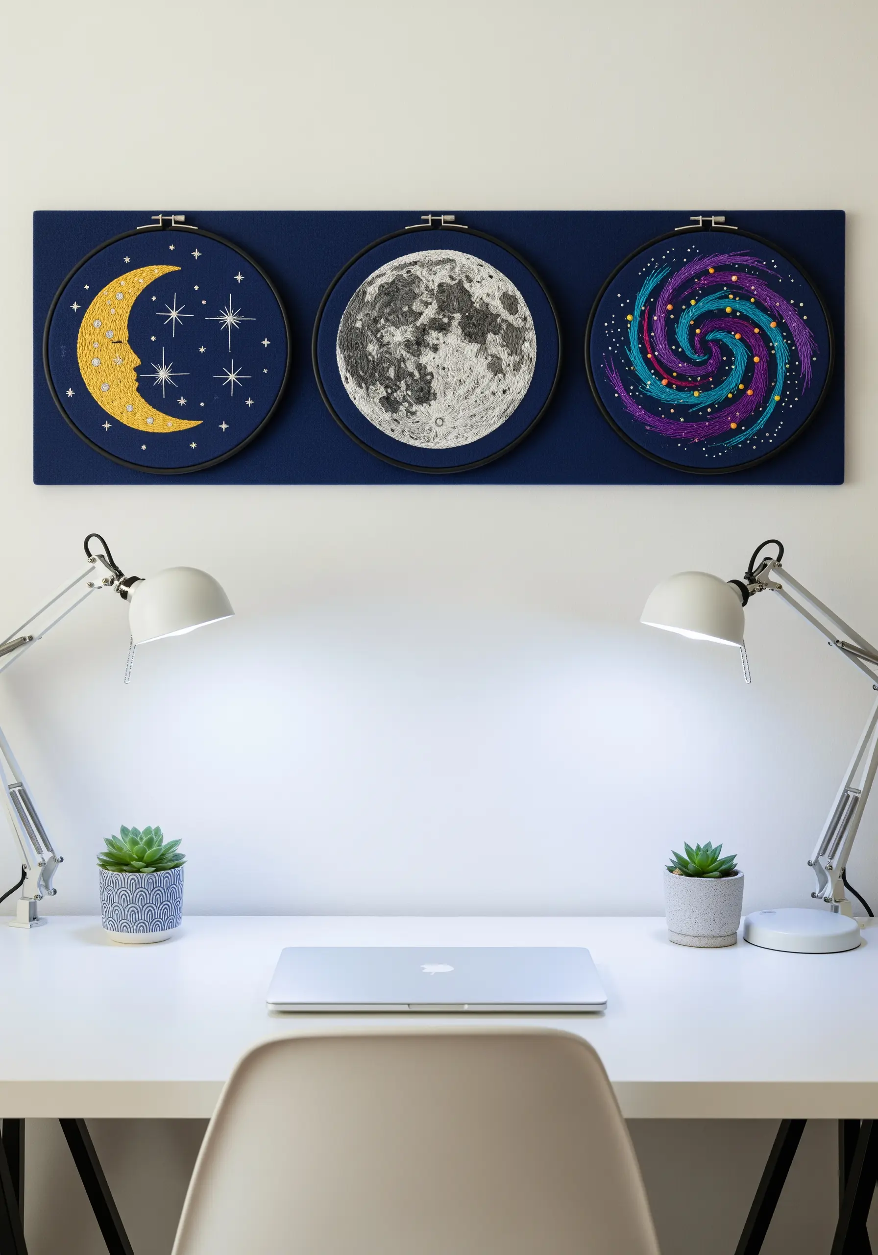 A trio of celestial embroidery hoops: a crescent moon, a full moon, and a colorful galaxy.