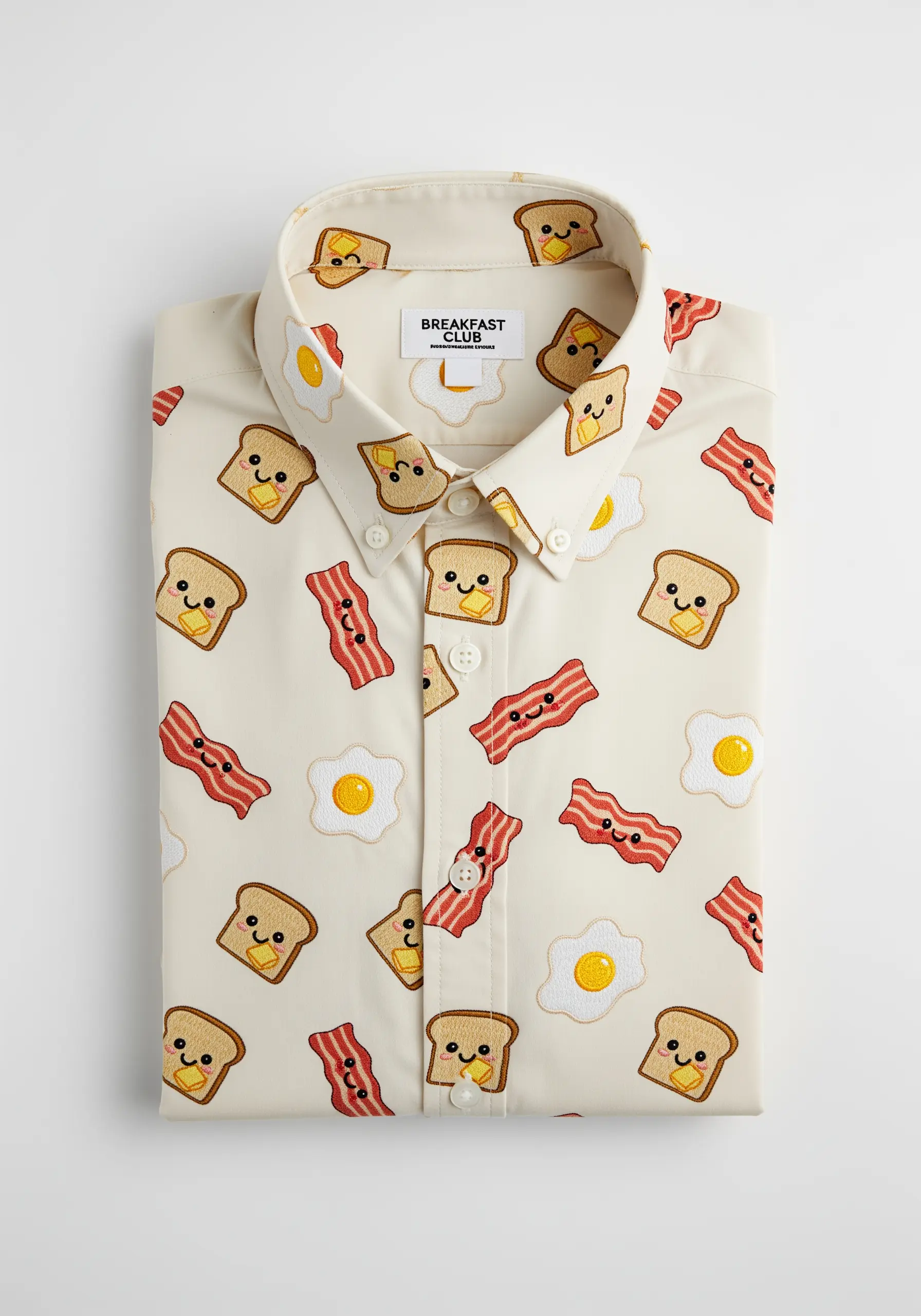 An all-over pattern of embroidered cartoon breakfast foods on a button-down shirt