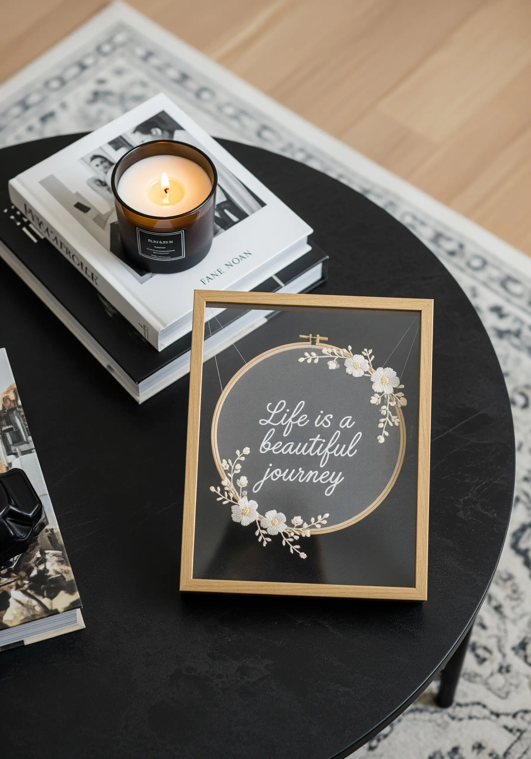 A quote and floral wreath embroidered on sheer fabric inside a floating glass frame.