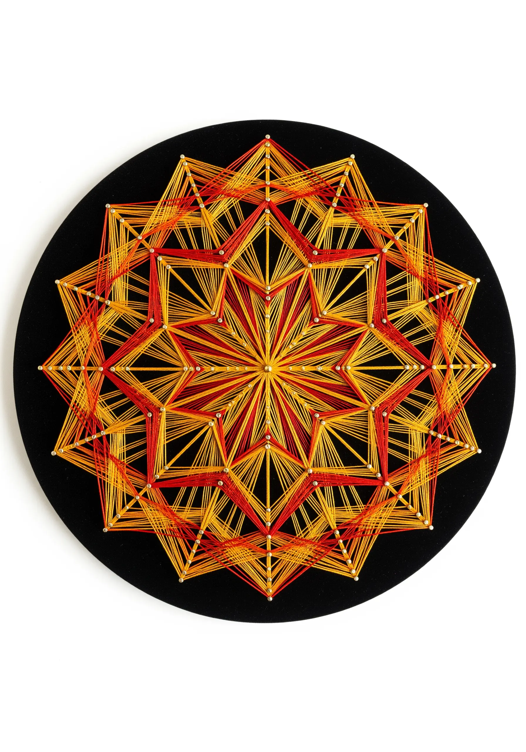 Geometric string art mandala with a red, orange, and yellow gradient on a black circular board