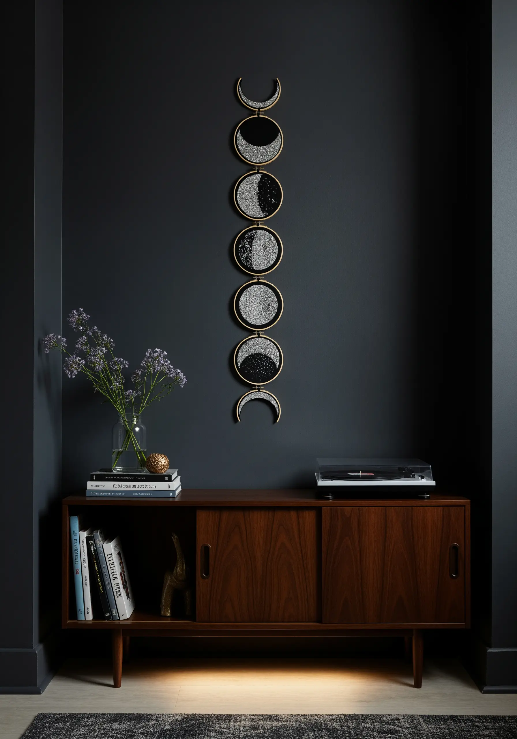 A vertical wall hanging of embroidery hoops depicting the phases of the moon.