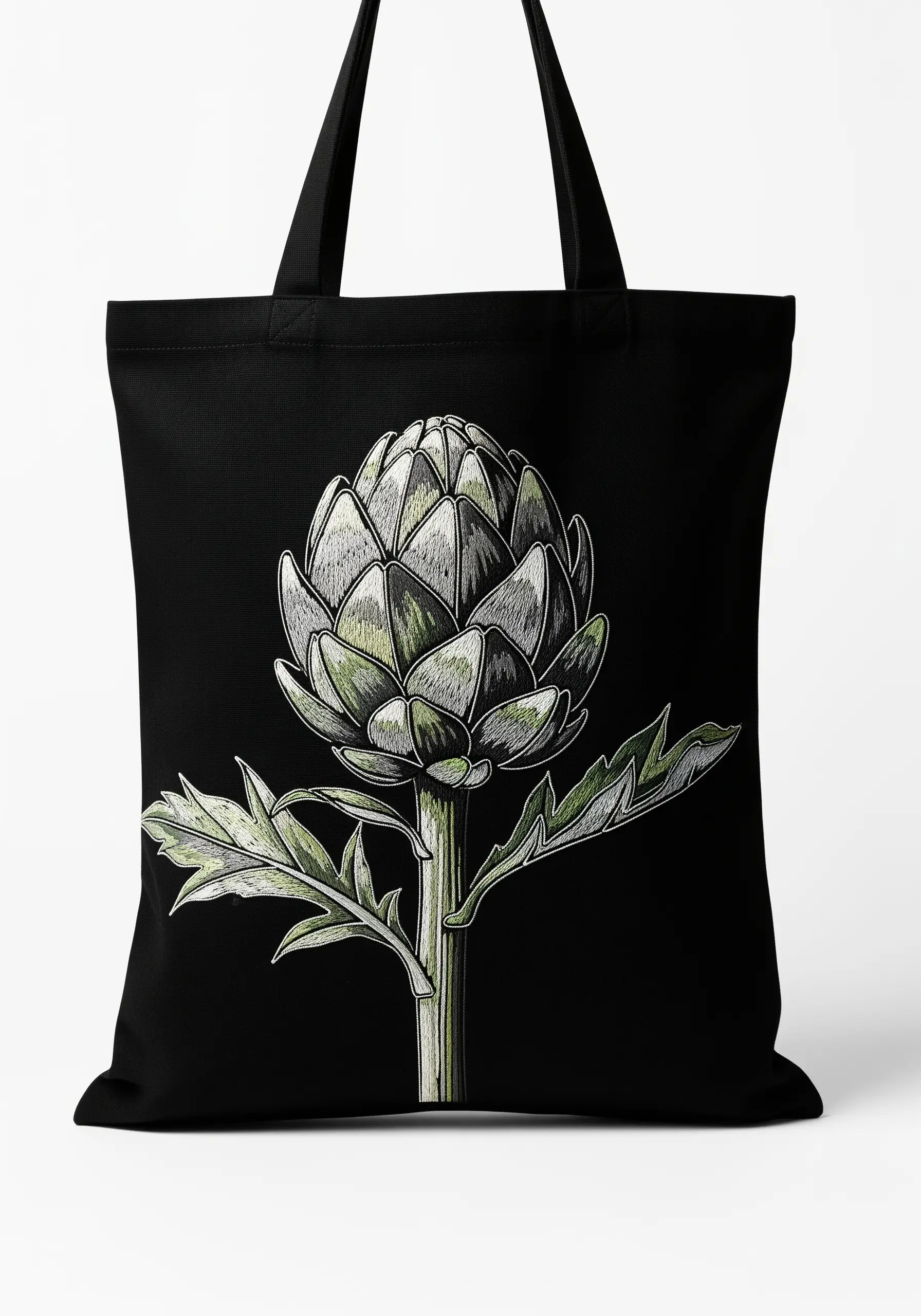 A detailed, illustrative-style embroidery of an artichoke on a black canvas tote bag.