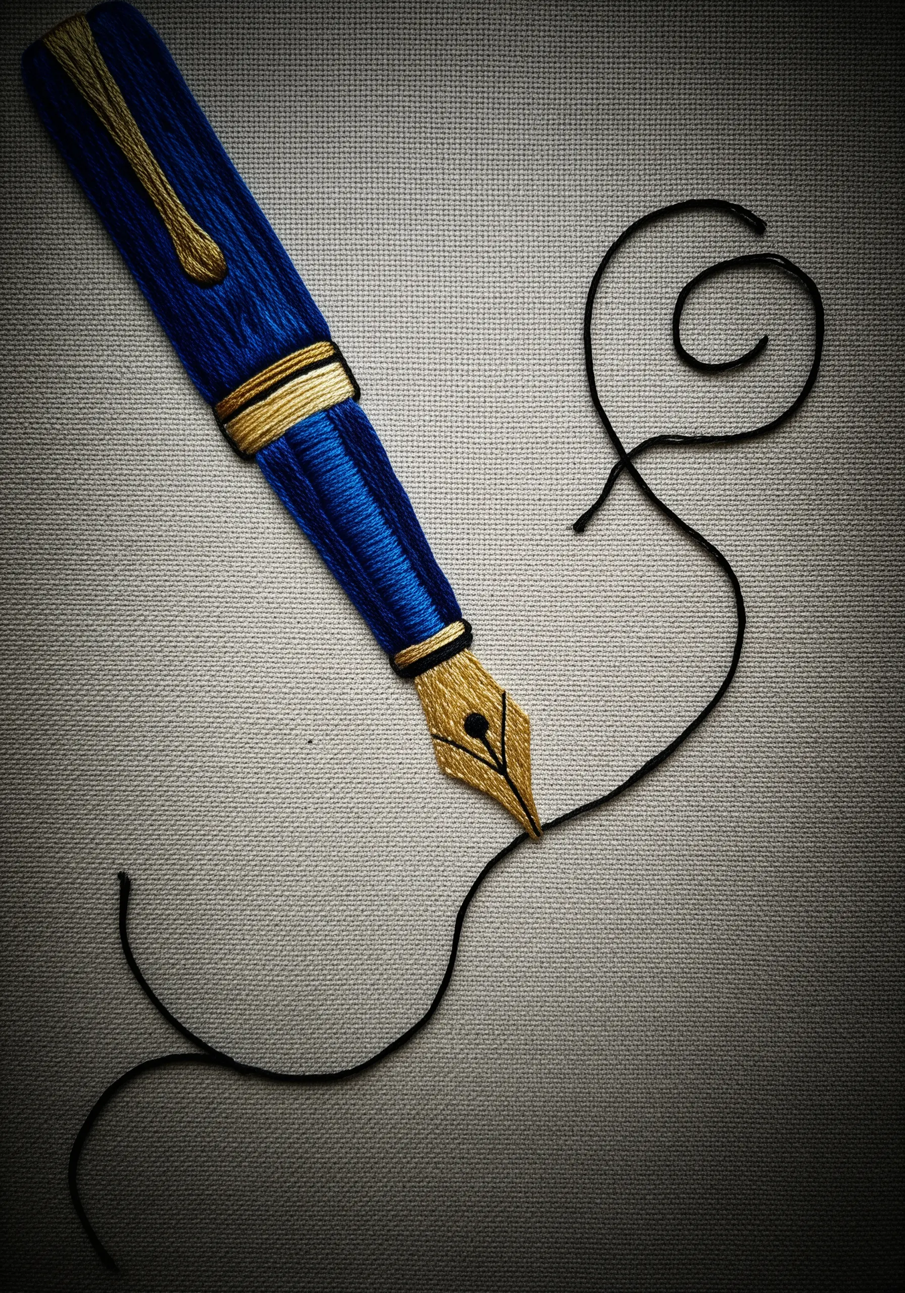 A royal blue and gold fountain pen embroidered with a glossy finish.