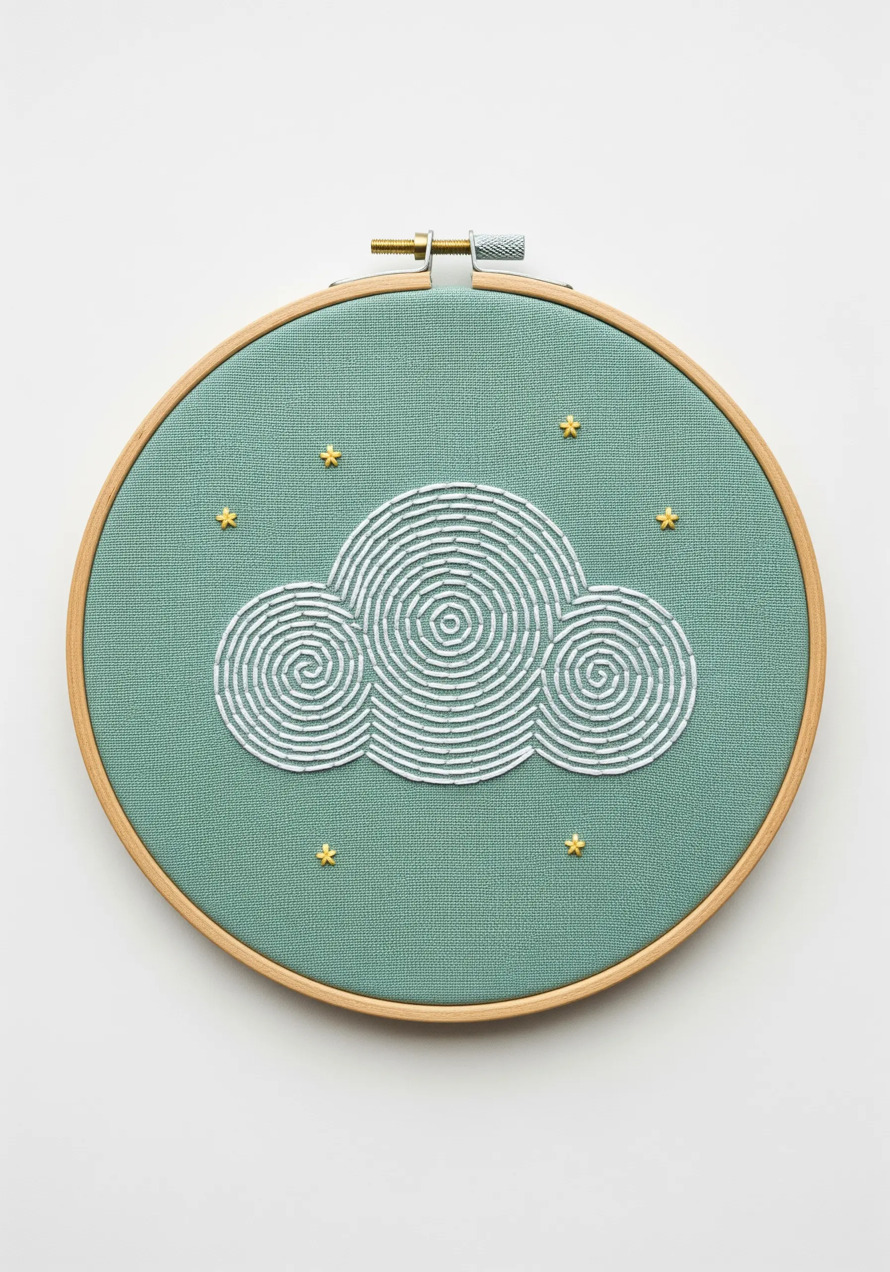 A cloud filled with concentric spirals of white seed stitches on a teal background.