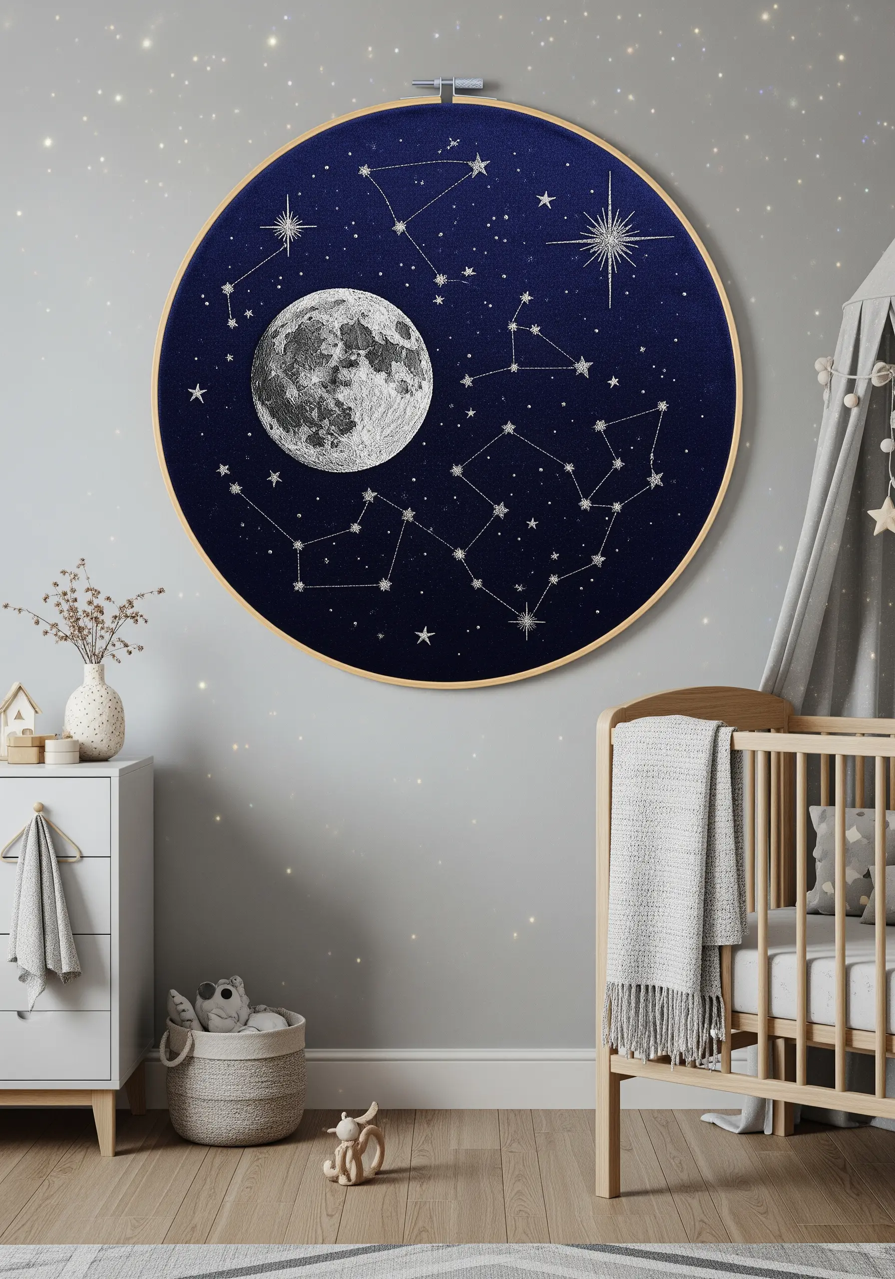 Detailed embroidery of the moon and constellations on dark blue fabric in a hoop.