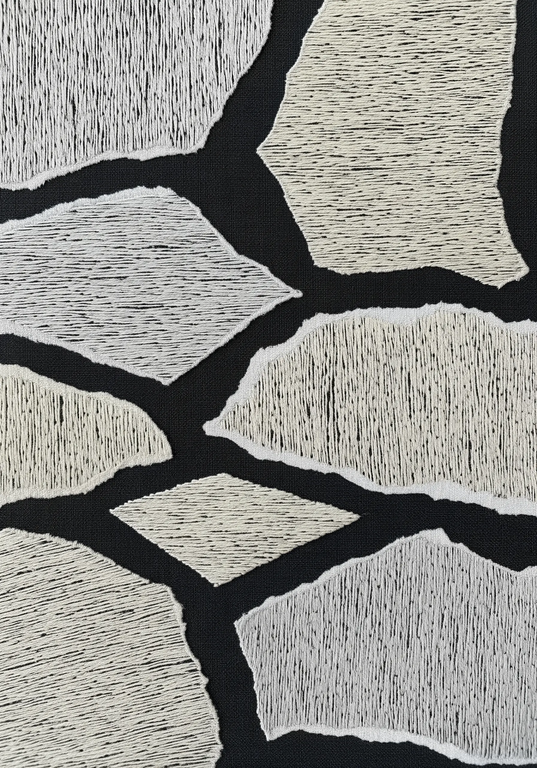 Abstract shapes on black fabric filled with dense off-white stitches and raw, uneven edges.
