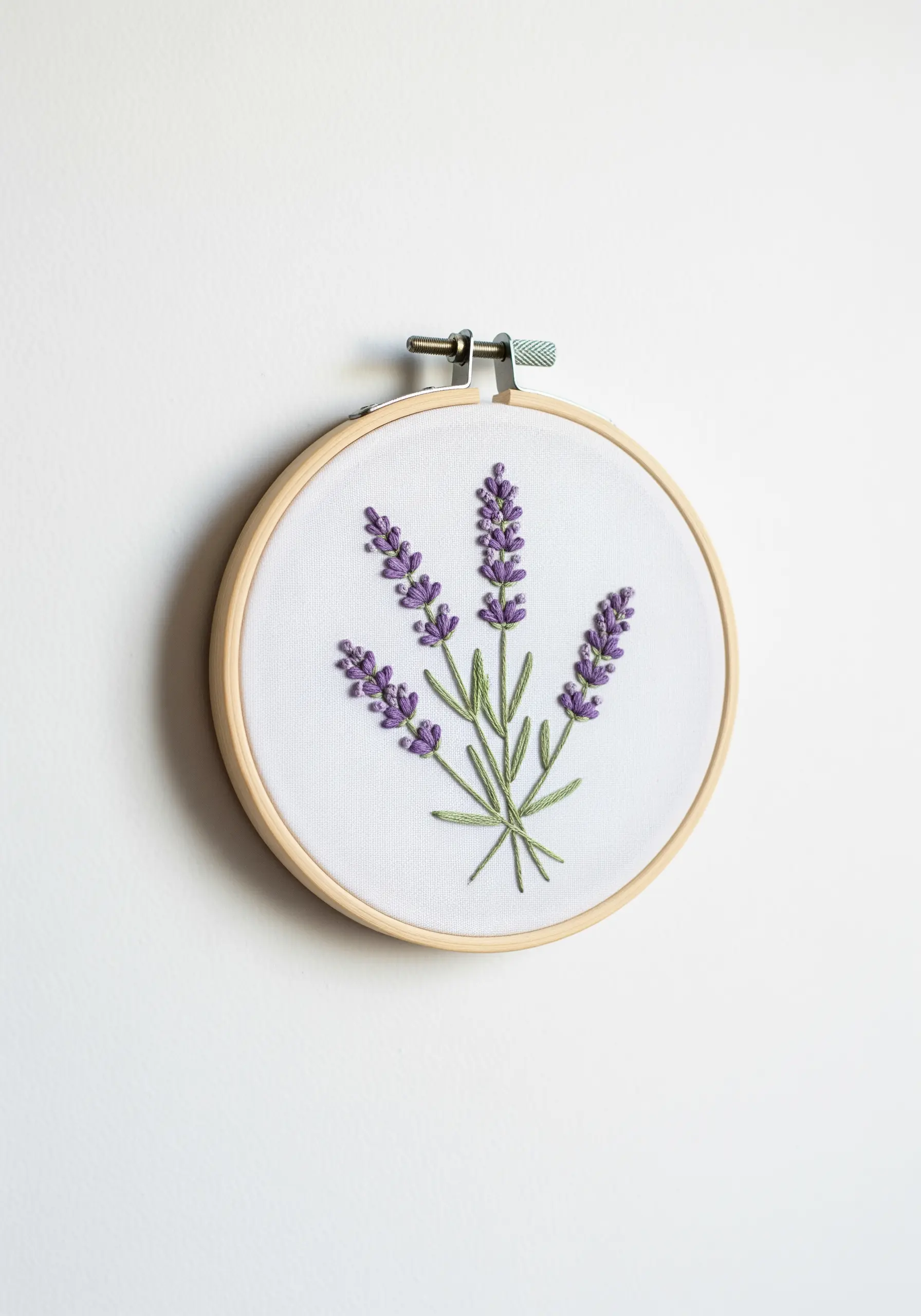 A bouquet of lavender embroidered with green stems and purple lazy daisy stitches.