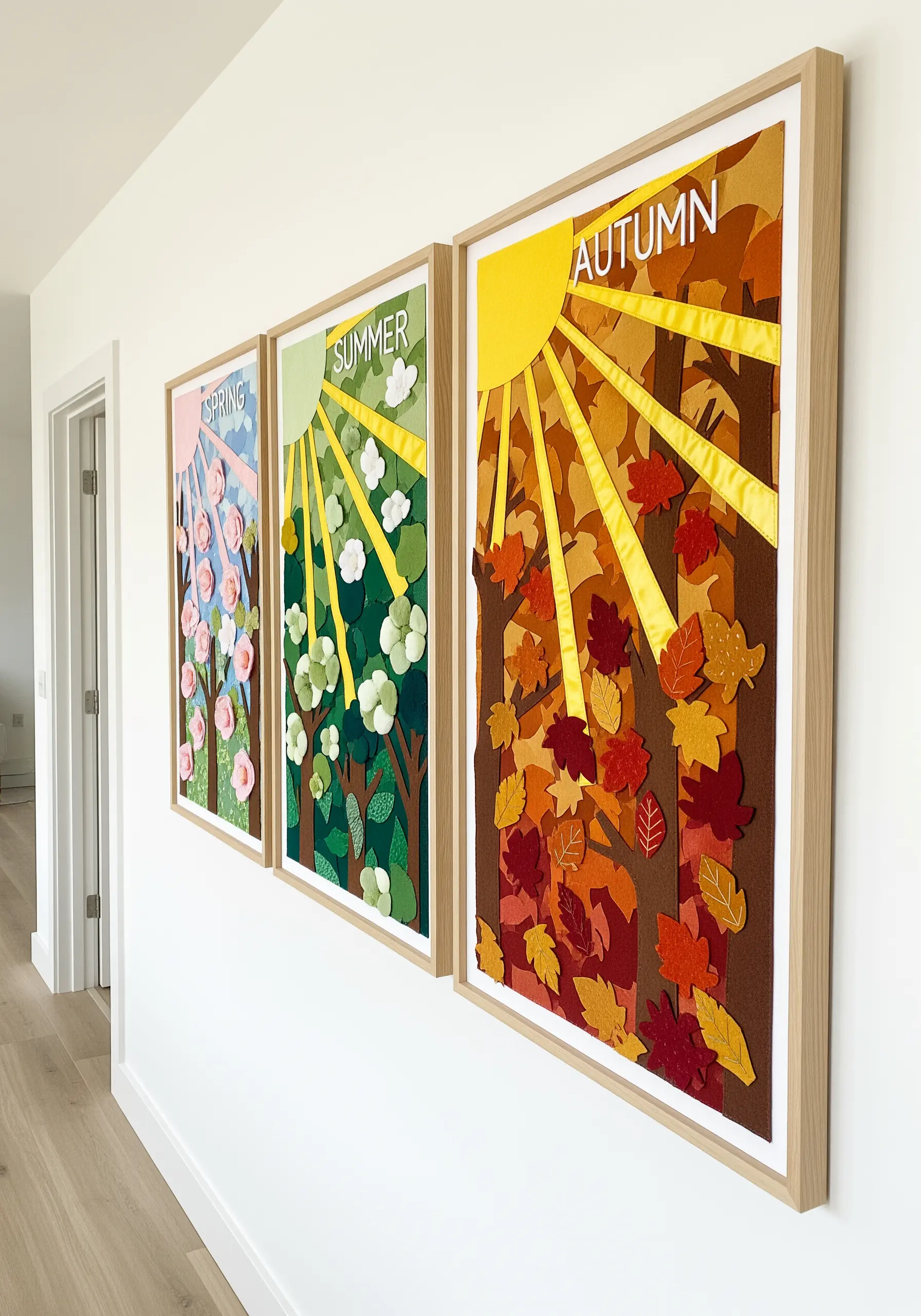 Four seasons wall art panels made from layered felt appliqué with 3D elements.