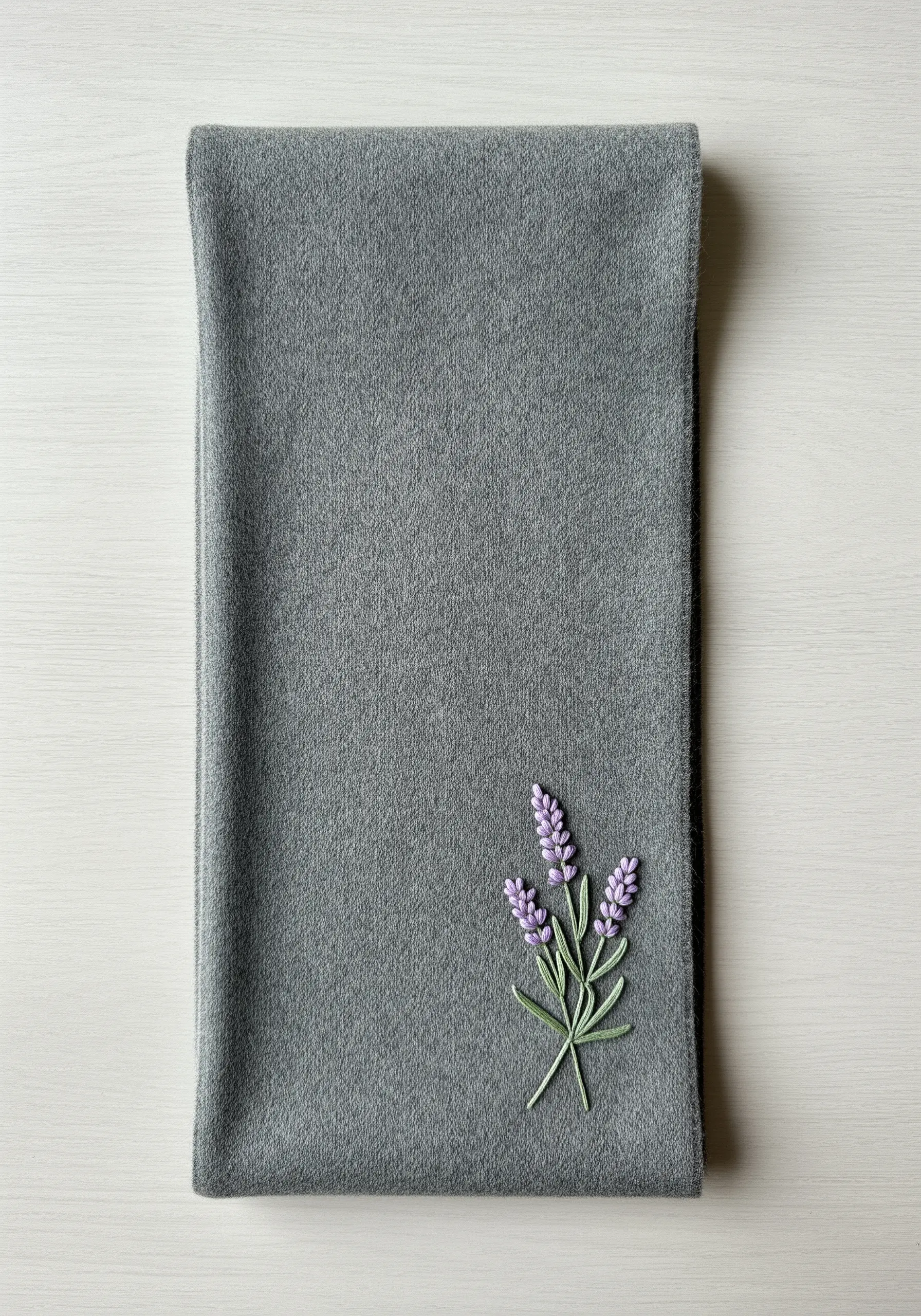 3D embroidered lavender sprig with French knots on a grey wool scarf.