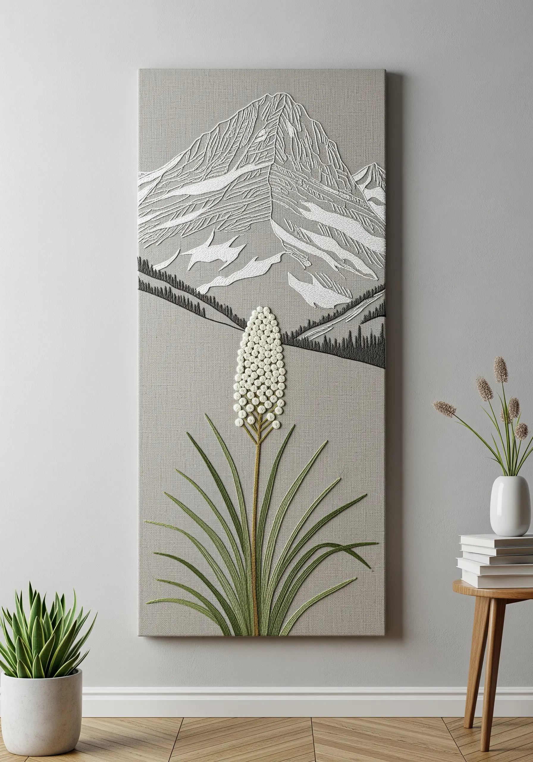 Minimalist mountain embroidery on a large canvas, with a dimensional white beaded flower.