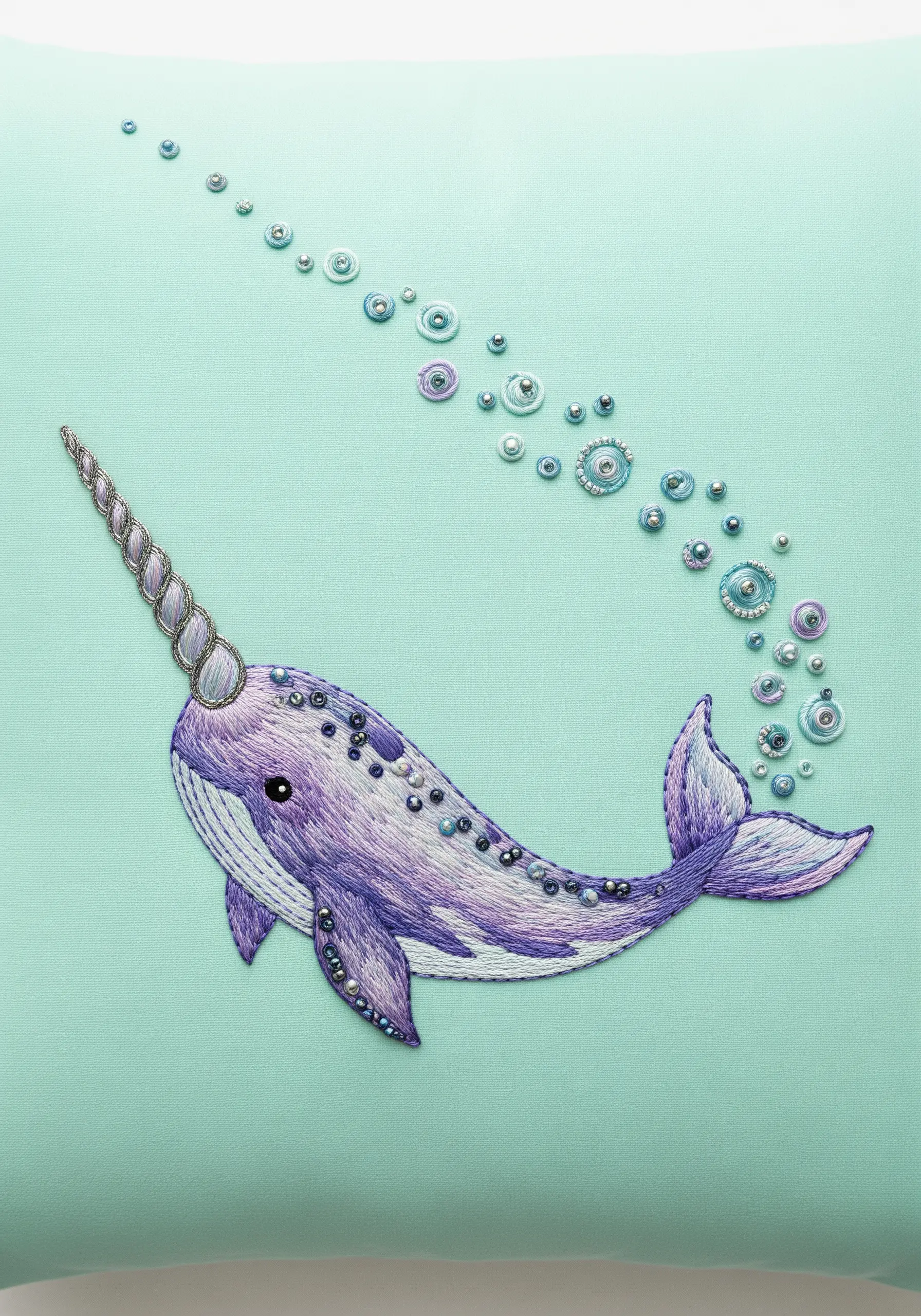 Embroidered narwhal with purple and silver bead and sequin embellishments.