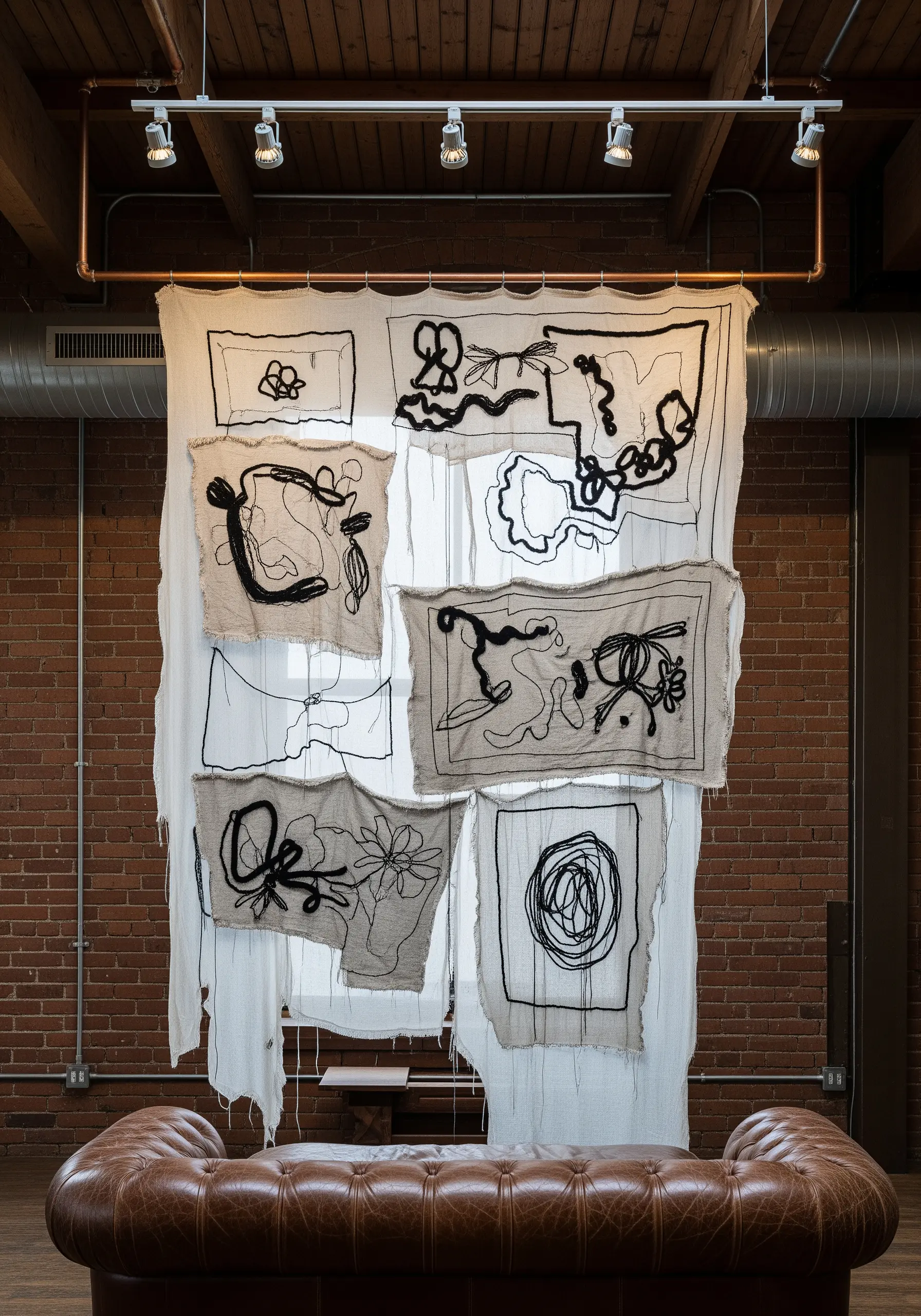 An abstract tapestry made from multiple stitched fabric scraps with black line embroidery.