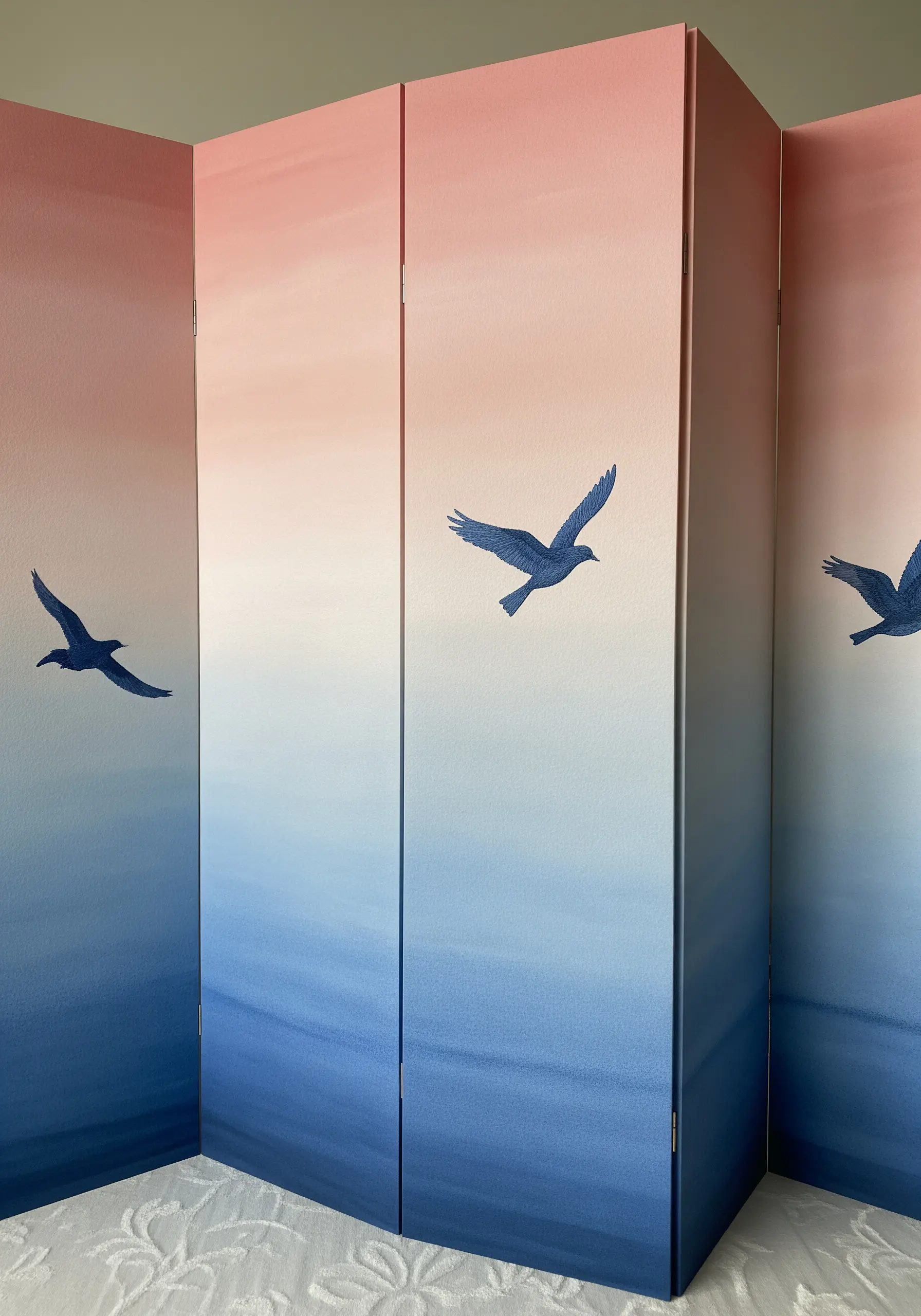A folding paper screen with a pink-to-blue gradient, featuring embroidered bird silhouettes.