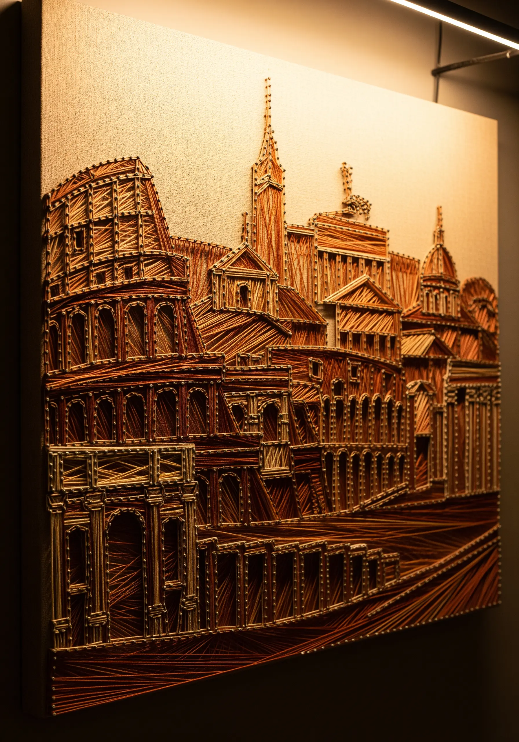 Intricate string art of Rome's skyline in shades of brown, terracotta, and cream for a sepia effect.