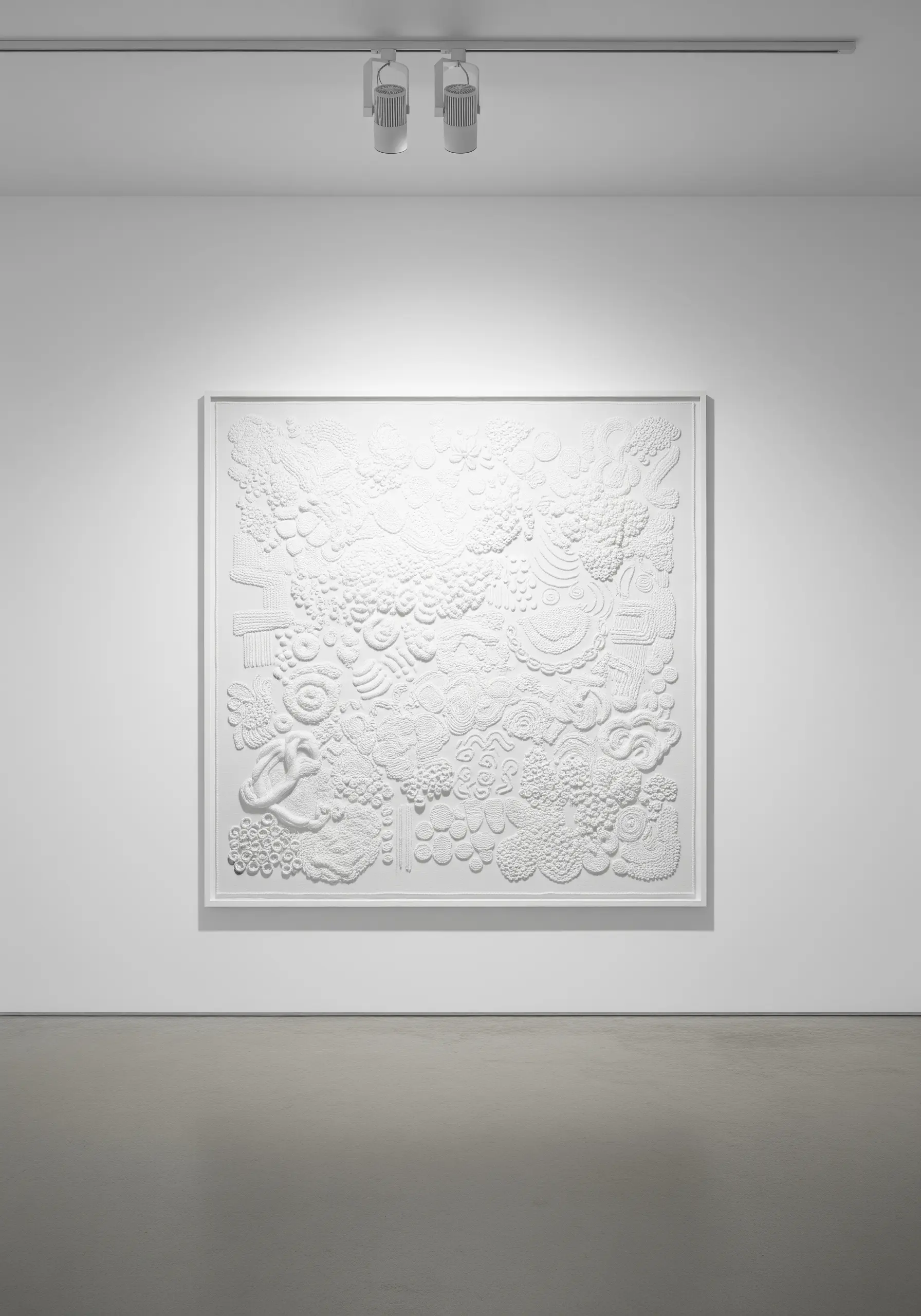 An all-white, highly textural abstract embroidery with dense knots and raised stitches.