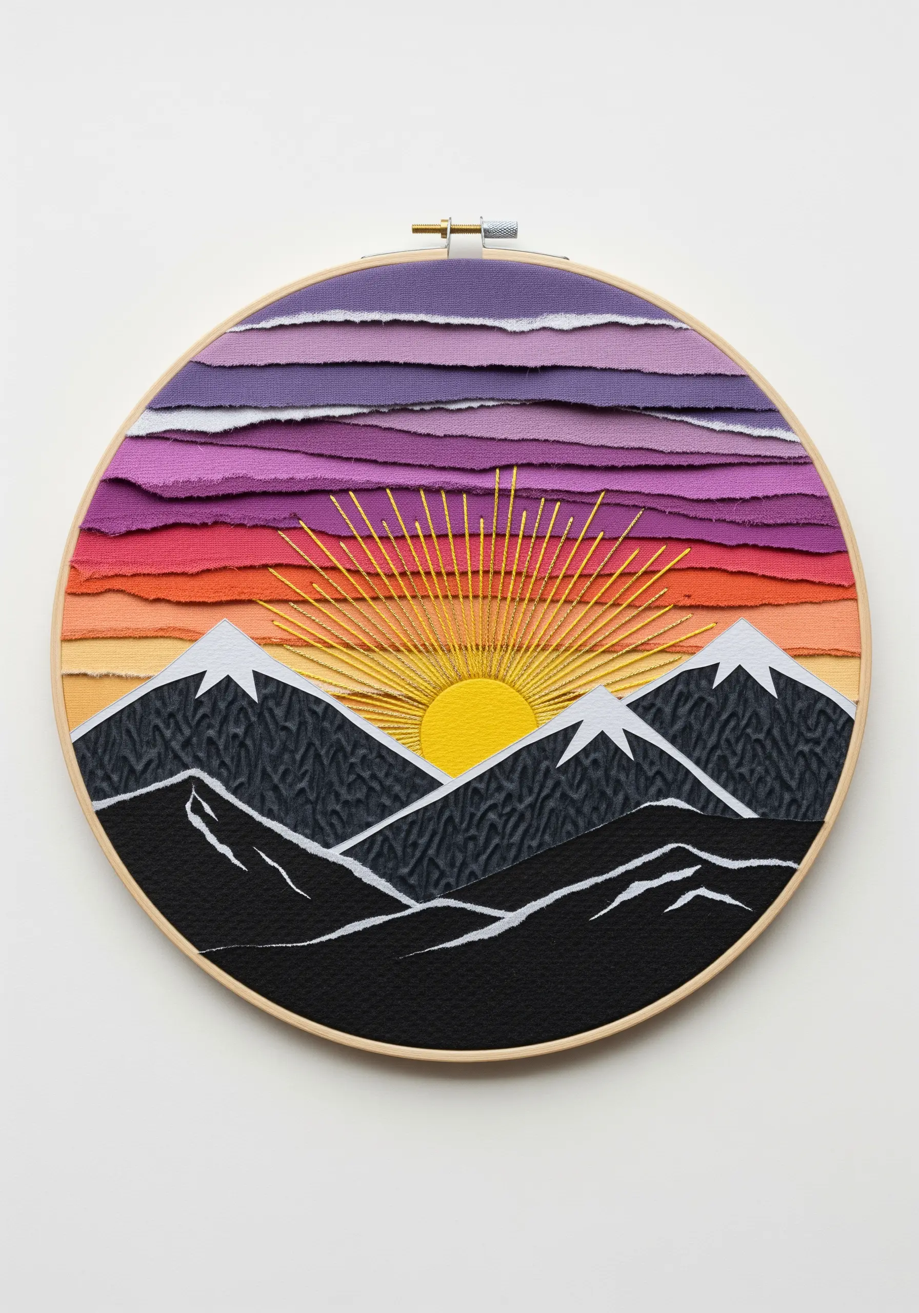 Mountain landscape made from torn fabric strips for the sky and a sunburst of yellow thread.
